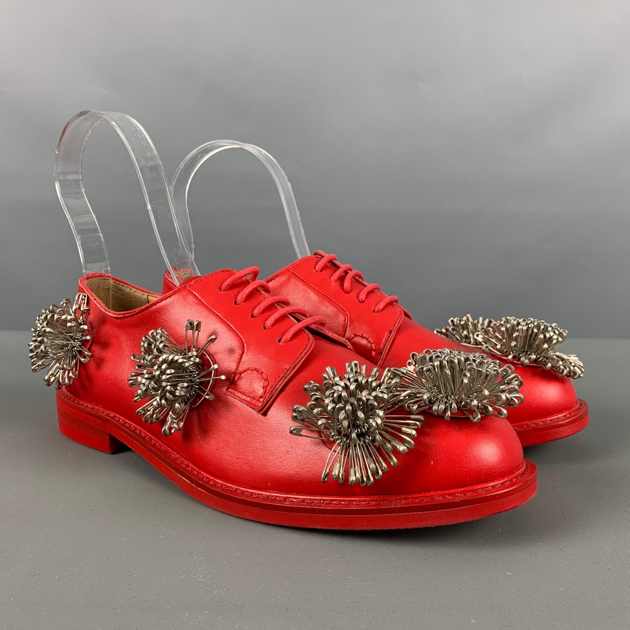 NOIR KEI NINOMIYA CHURCH'S shoes comes in a red leather material featuring silver safety pin details, round toe, and a leather lace up closure. Excellent Pre-Owned Condition.  

Marked:   D 60216Outsole: 10.75 inches  x 3.75 inches  
  
  

