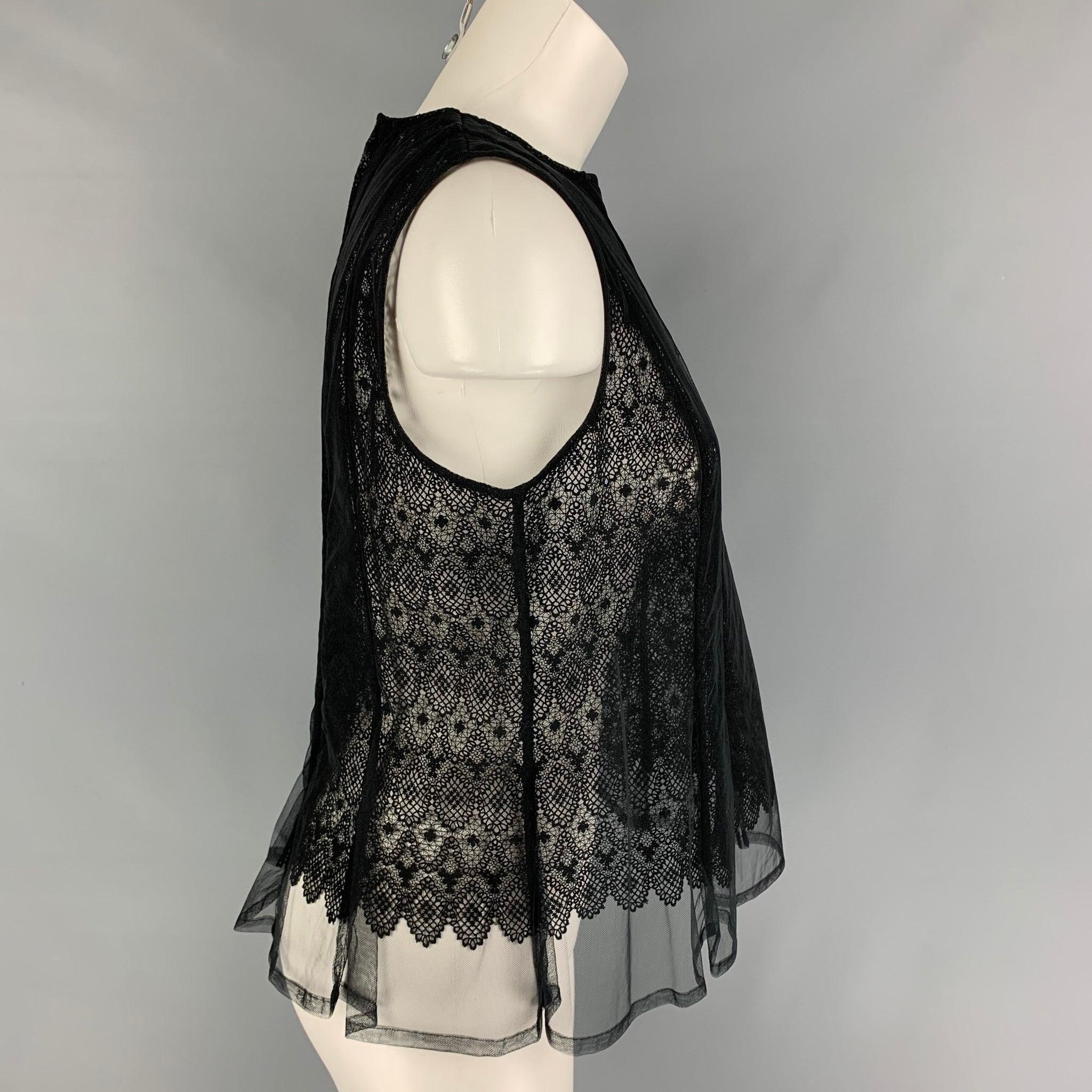 NOIR KEI NINOMIYA top comes in a black lace tulle material featuring a overlay design, sleeveless, and a back zip up closure.
Excellent Pre-Owned Condition.  

Marked:   M  

Measurements: 
 
Shoulder: 14 inches Bust: 32 inches Length: 22 inches 
 