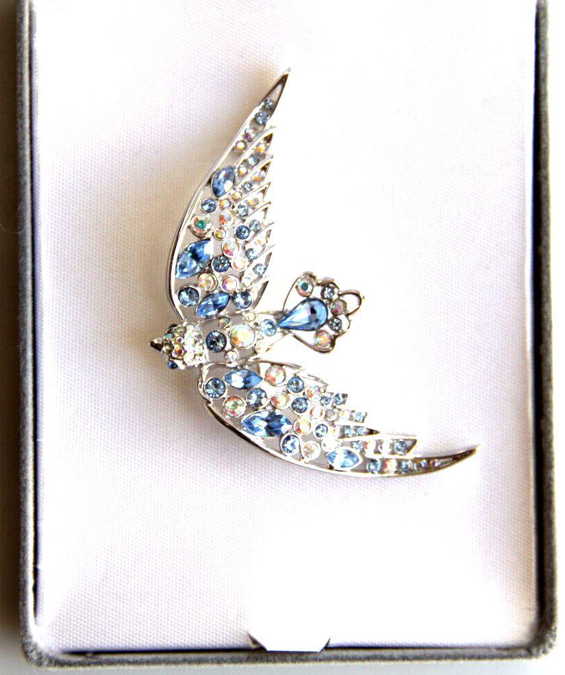 Simply Beautiful! Rare Vintage Designer Brooch by Nolan Miller featuring a Flying Bird Hand set with sparkling Crystals. Silver Tone mounting. Measuring approx. 2.75