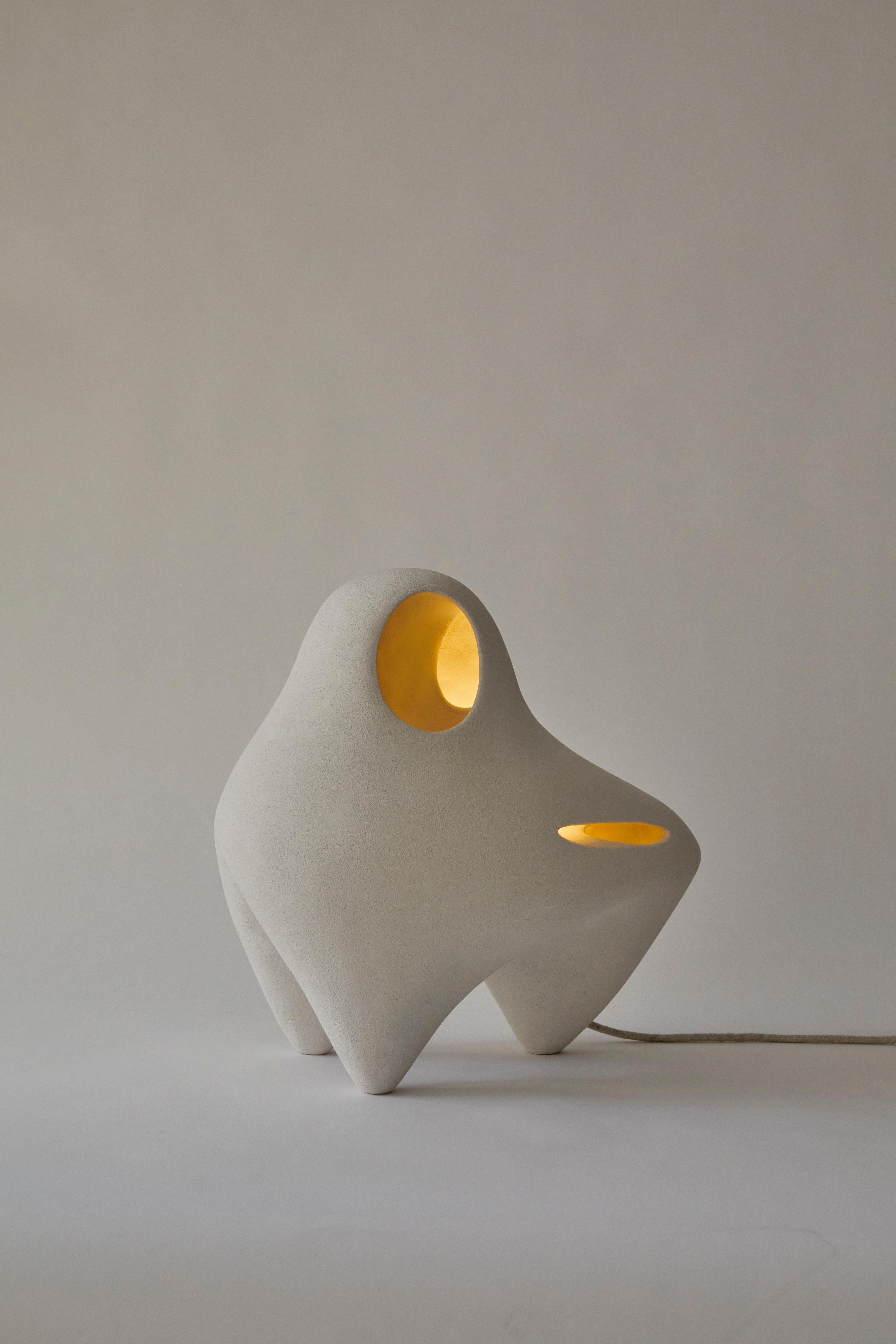 Nomad II:03 Table Lamp in White Sand Stoneware by Sofia Karnukaeva
Dimensions: D 48 x W 25 x H 41 cm.
Materials: Stoneware.

All our lamps can be wired according to each country. If sold to the USA it will be wired for the USA for instance. Please