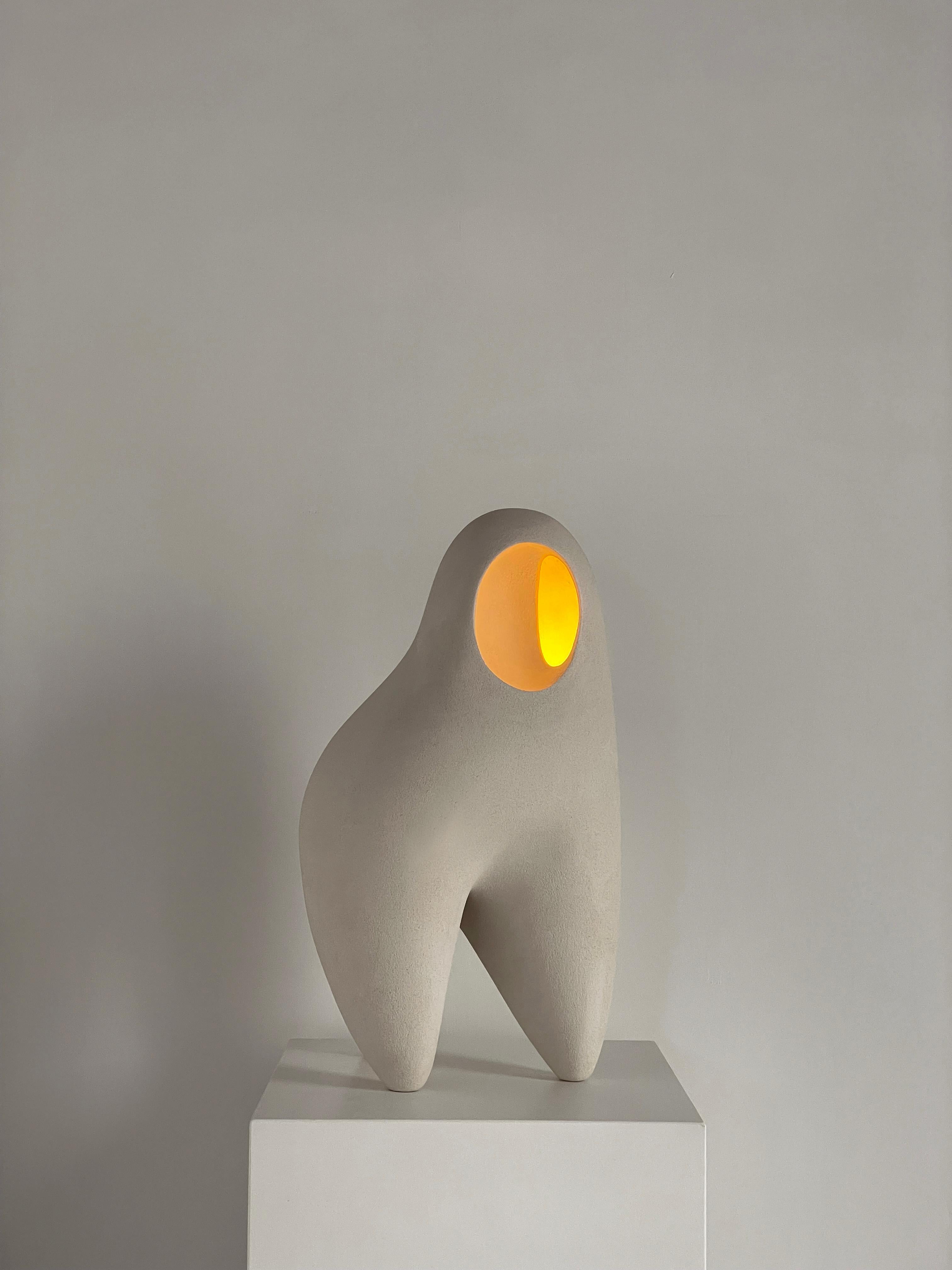 Nomad II:08 Table Lamp in White Sand Stoneware by Sofia Karnukaeva
Dimensions: D 33 x W 22 x H 49 cm.
Materials: Stoneware.

All our lamps can be wired according to each country. If sold to the USA it will be wired for the USA for instance. Please