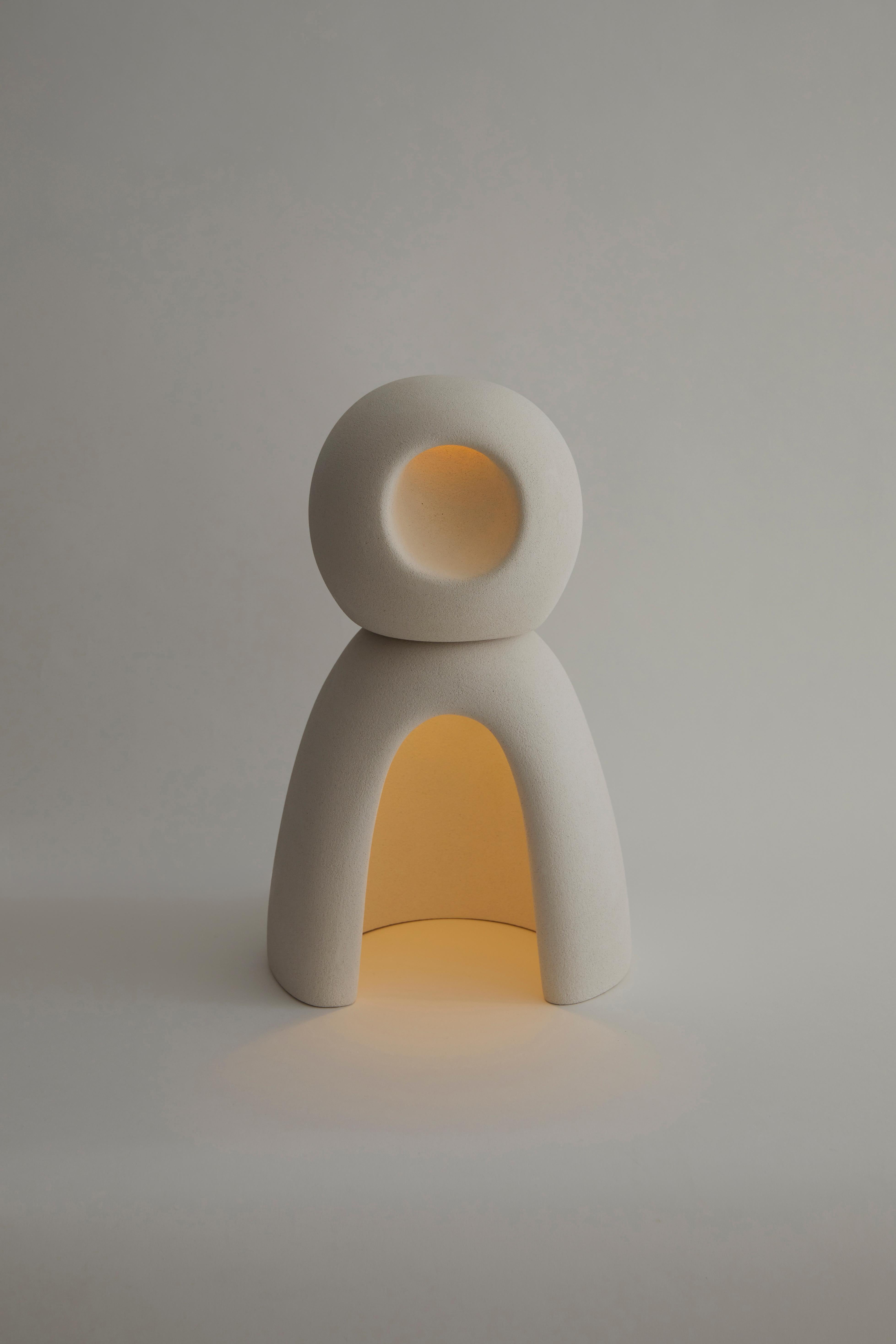 Nomad II:09 Table Lamp in White Sand Stoneware by Sofia Karnukaeva
Dimensions: D 33 x W 22 x H 49 cm.
Materials: Stoneware.

All our lamps can be wired according to each country. If sold to the USA it will be wired for the USA for instance. Please
