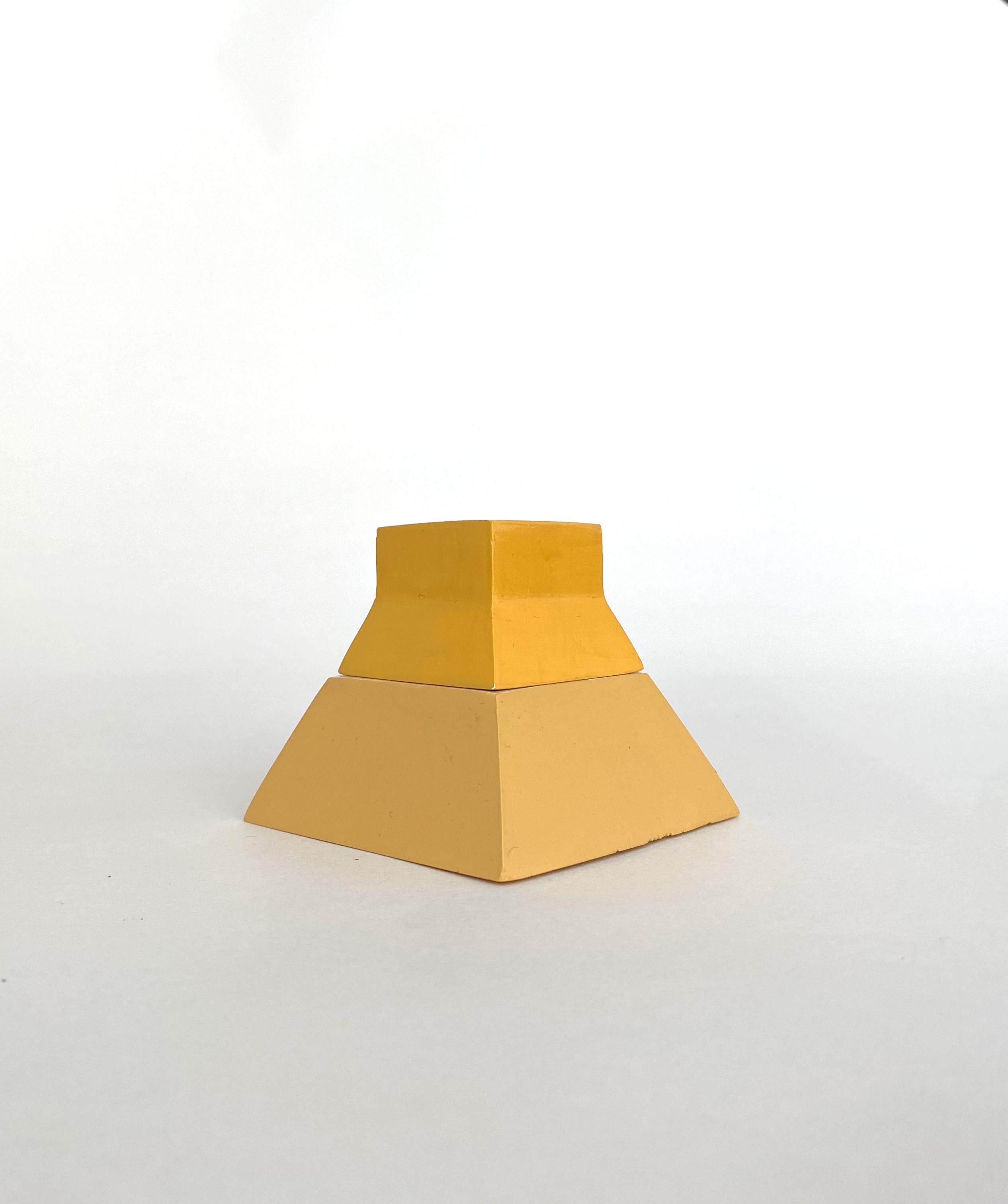 Nomad Jar Laurence Pyramide by Gilles & Cecilie
Unique
Dimensions: H 6 x W 7 cm
Material: Ceramic painted two tone yellow

Gilles and Cecilie Studio created the Nomad Jar Family to explore drawing in three dimensions. The series of objects that