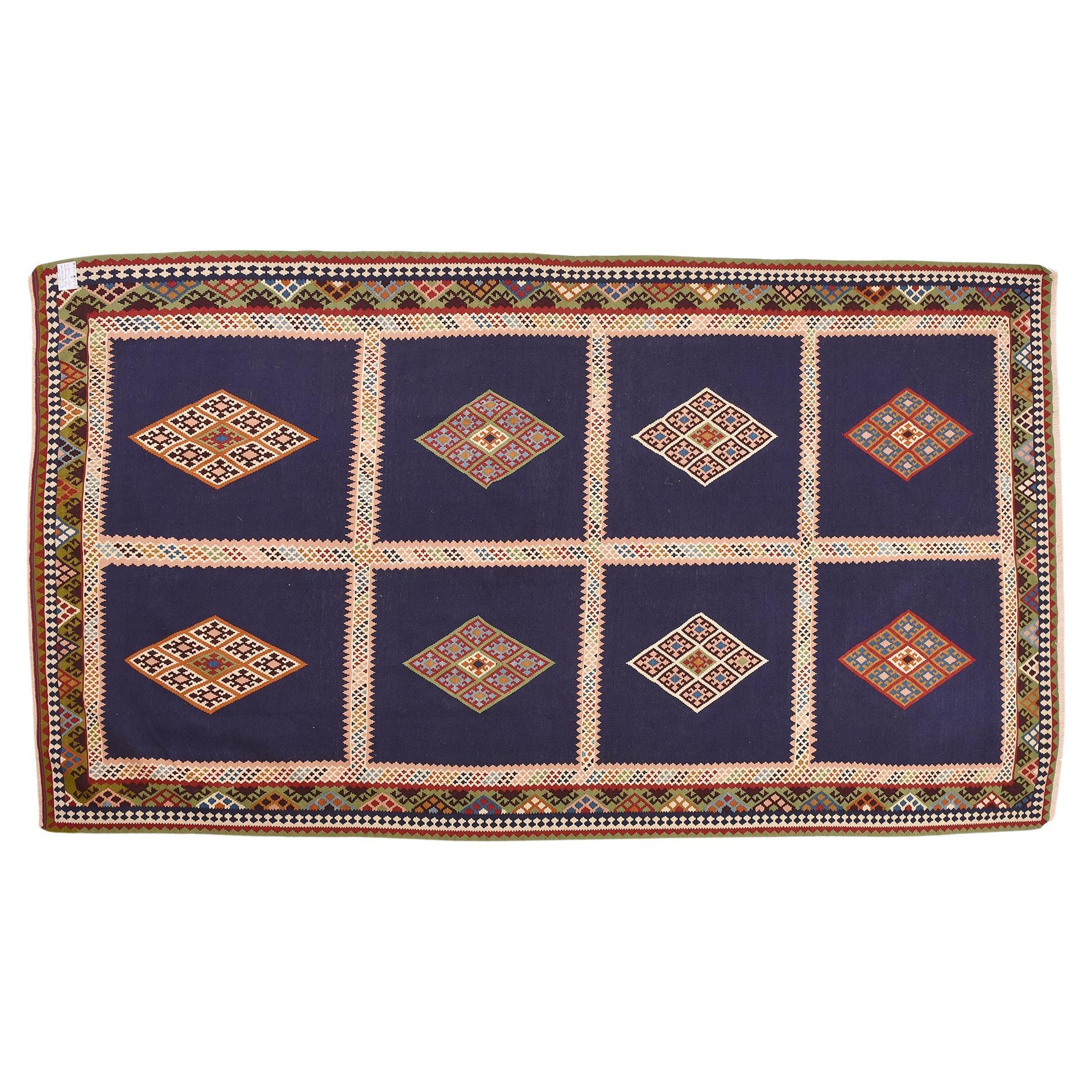 nr. 1016 - Perfect polychrome rhombuses on a blue background for this beautiful perfect kilim.  The rich frame has shades of green, a rare color to find in nomadic carpets.  Dense and accurate workmanship.
Perfect for a living room.