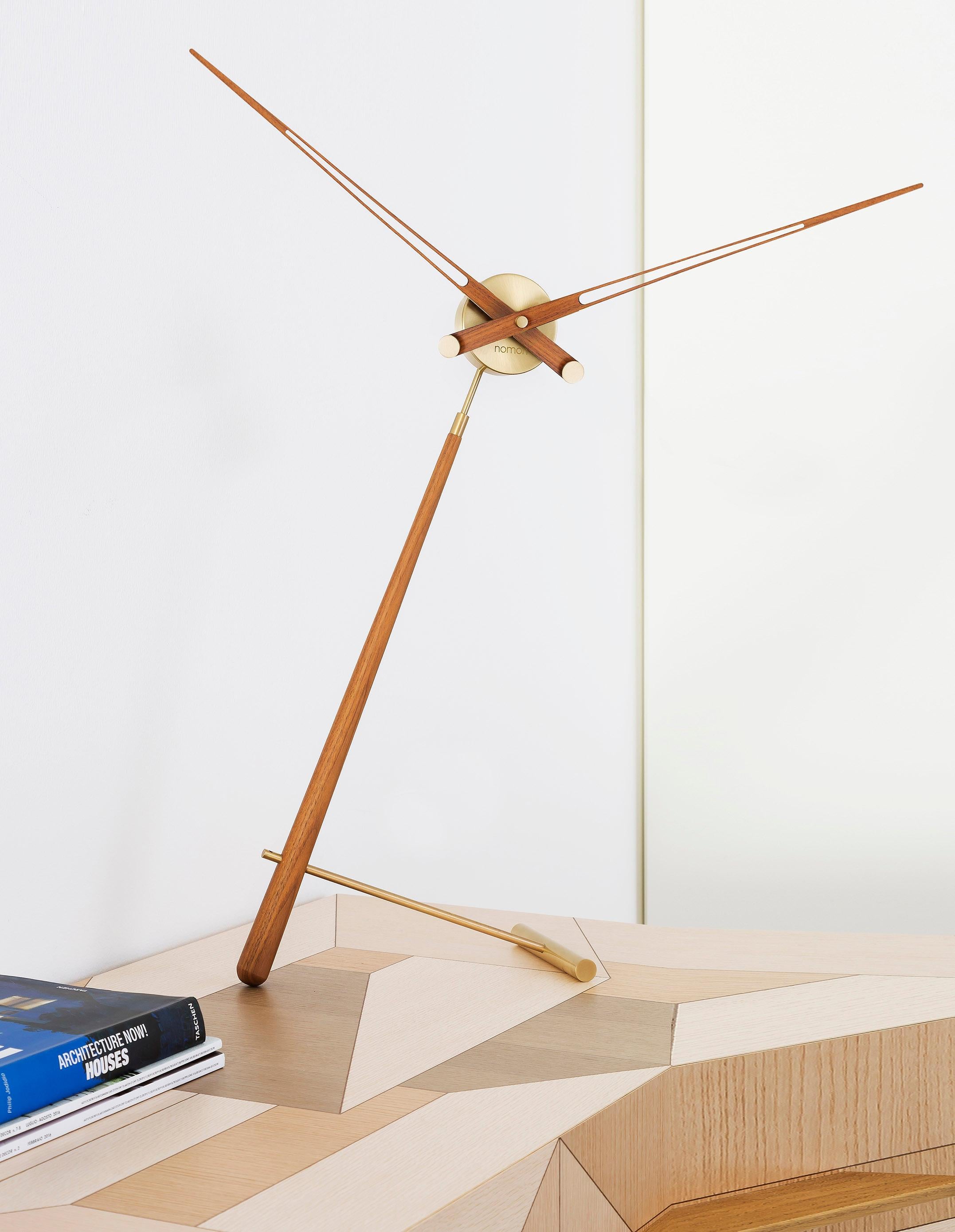 A magnificent and avant-garde design for a desktop clock. This design has the perfect combination between chromed steel and lacquered walnut wood giving this model a great touch, with its striking color, it makes this Nomon L pointer clock one of
