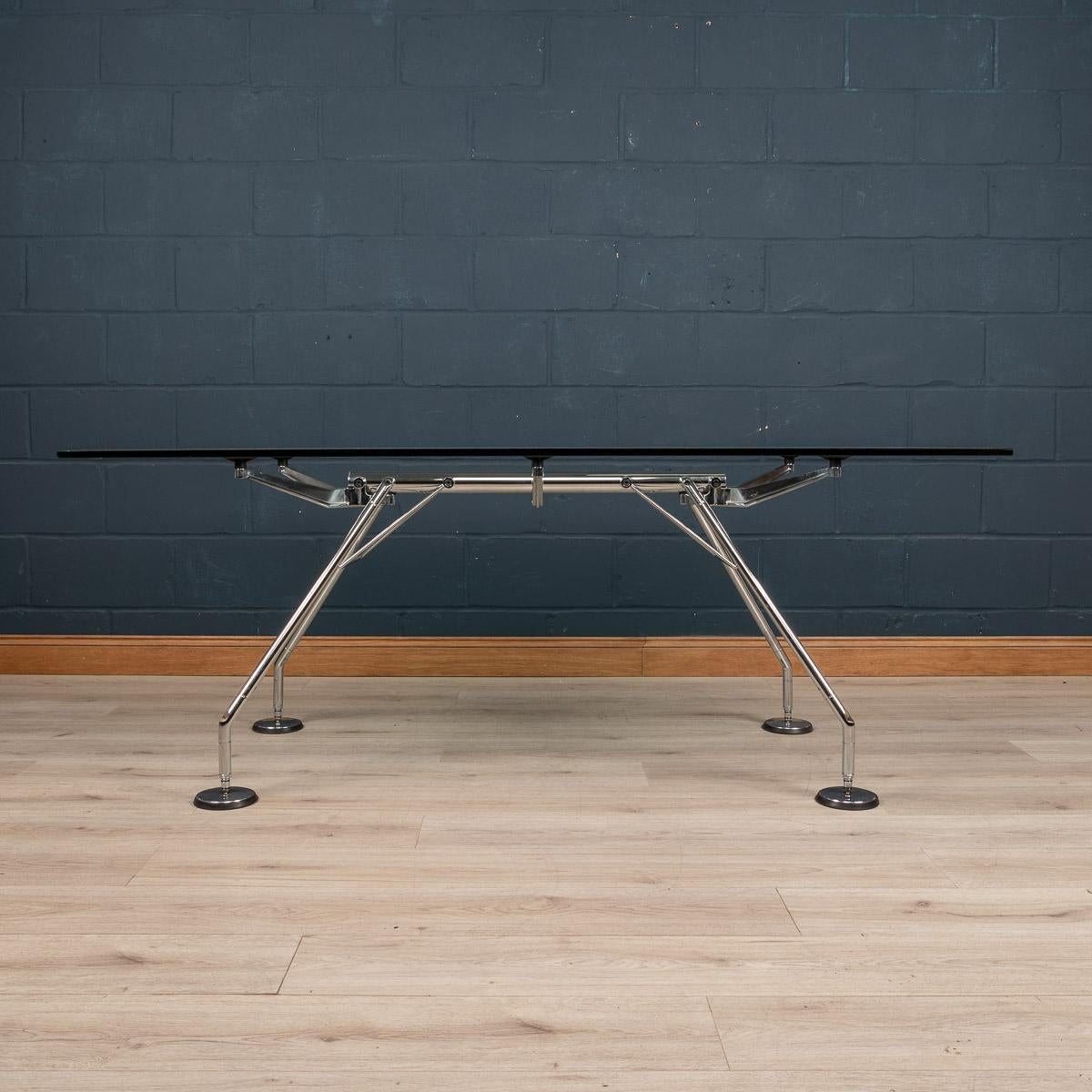 A dining table or office table designed by British architect Sir Norman Foster. The “Nomos” dining table was designed by Foster after he started working with another designer, Marco Fantoni of the Italian furniture manufacturers Tecno. The design