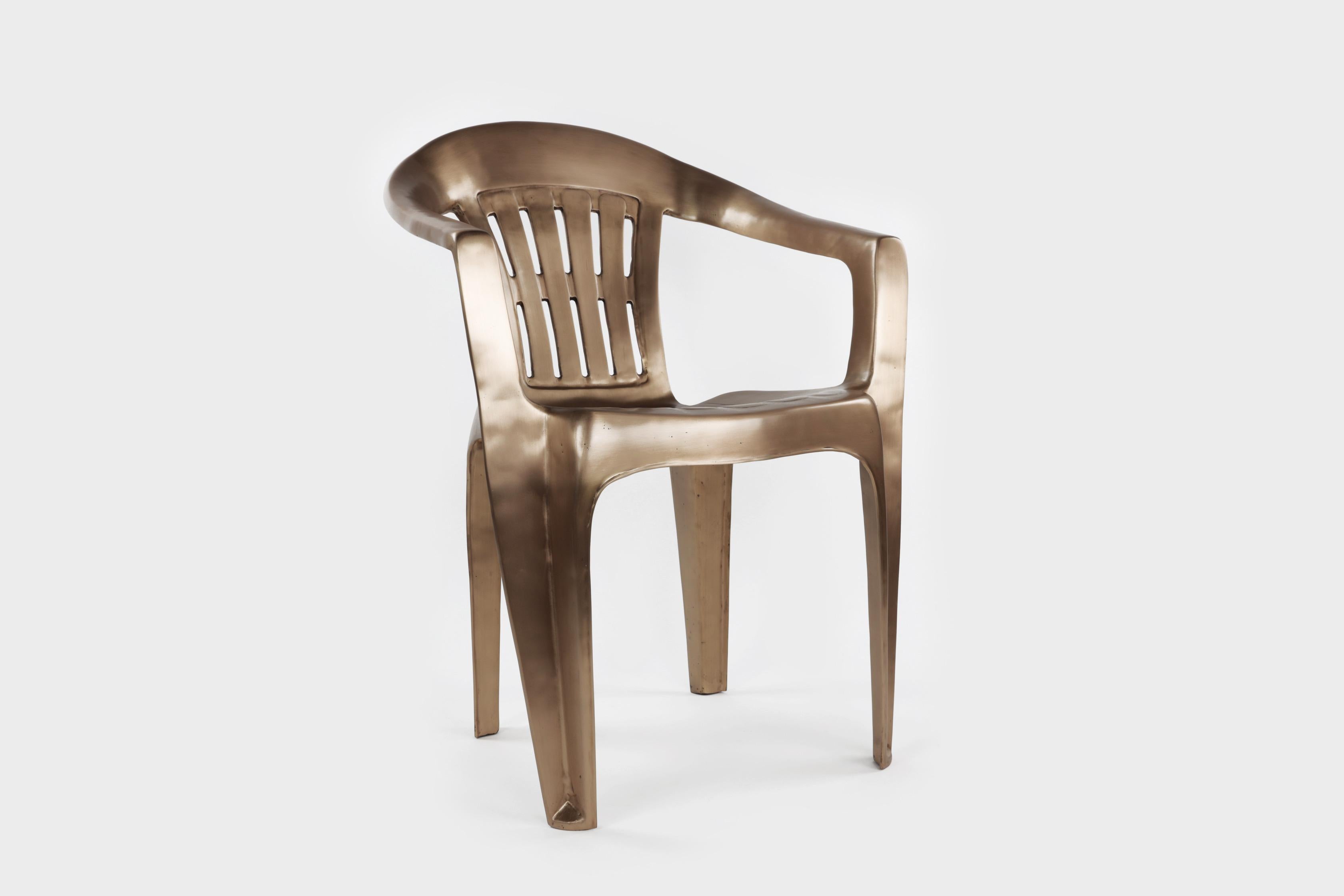 The Non-Disposable Disposable Chair, in bronze for indoor and outdoor use is a take on the famed Monobloc chair from 1965. The solid cast bronze chair has a satin finish. Each chair weighs about 30 pounds and can withstand weather. 
Signed.