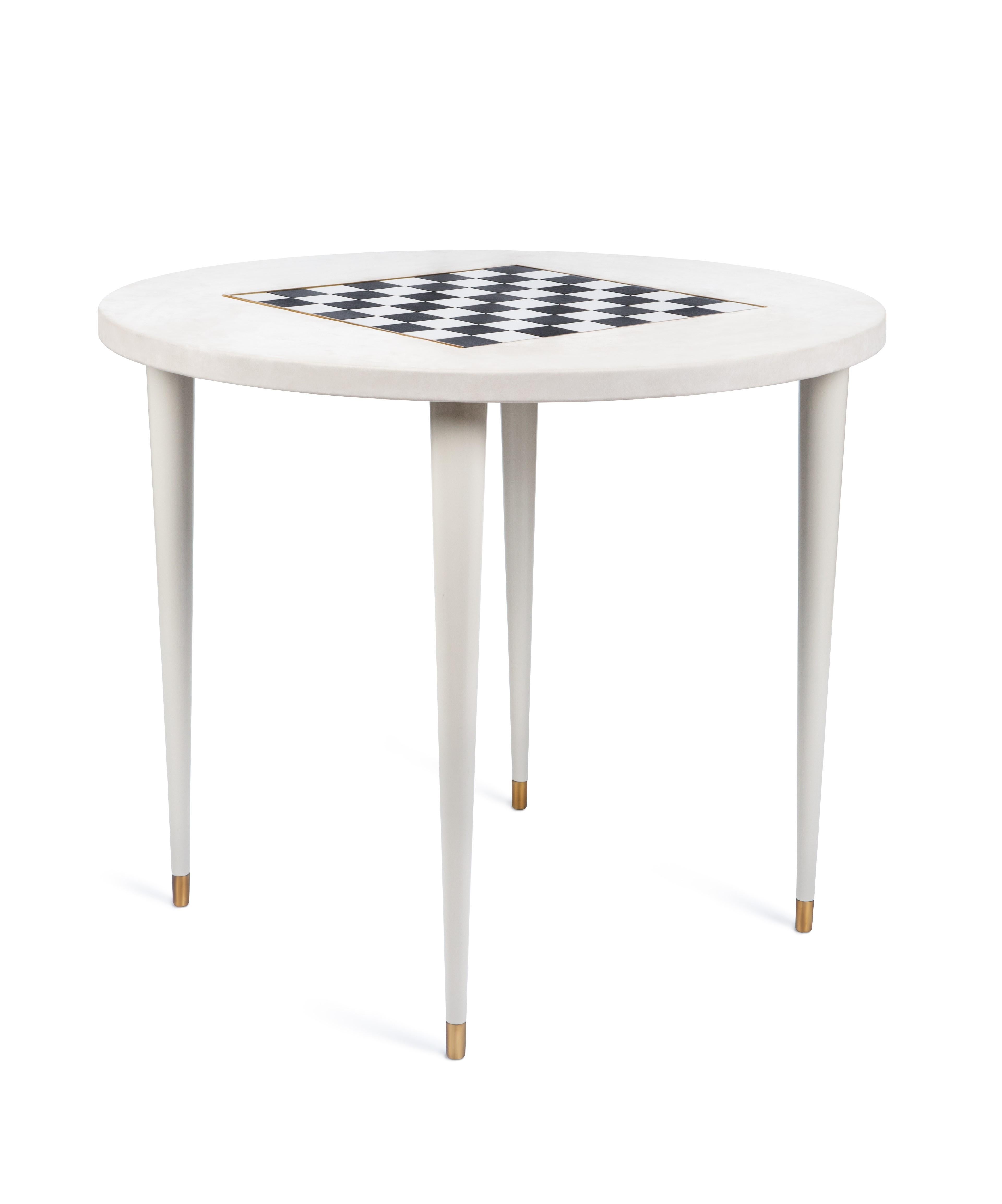 The elegant silhouette of the Non Smoking table is emphasized by the textured leather top and the embossed game board in black and white lacquer. The juxtaposition of contrasting materials gives a modern look to its classic and deceptively simple