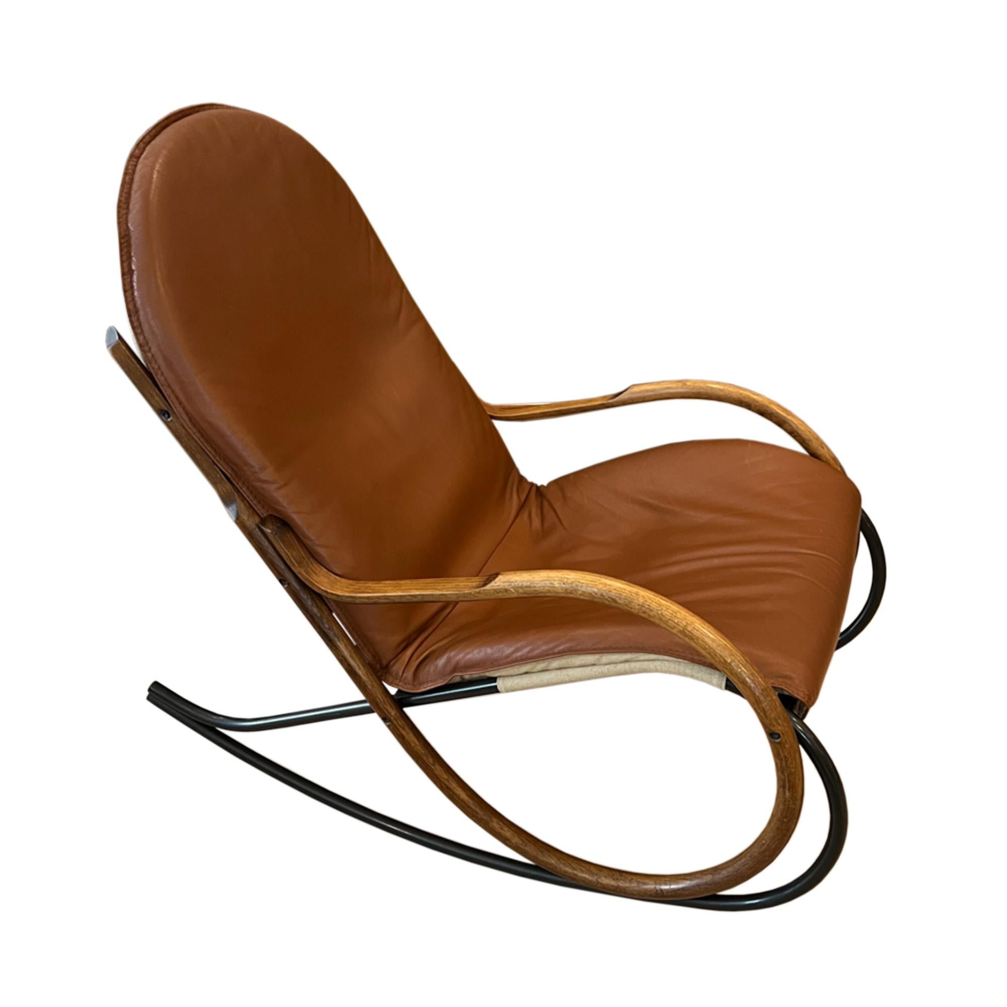 This elegant rocking chair was designed by Paul Tuttle for Strässle in Switzerland in the 1970s - the 'Nonna' model. 

The frame is made from bent wood and metal while the seat is linen and tan leather.

Super comfortable and decorative - this chair