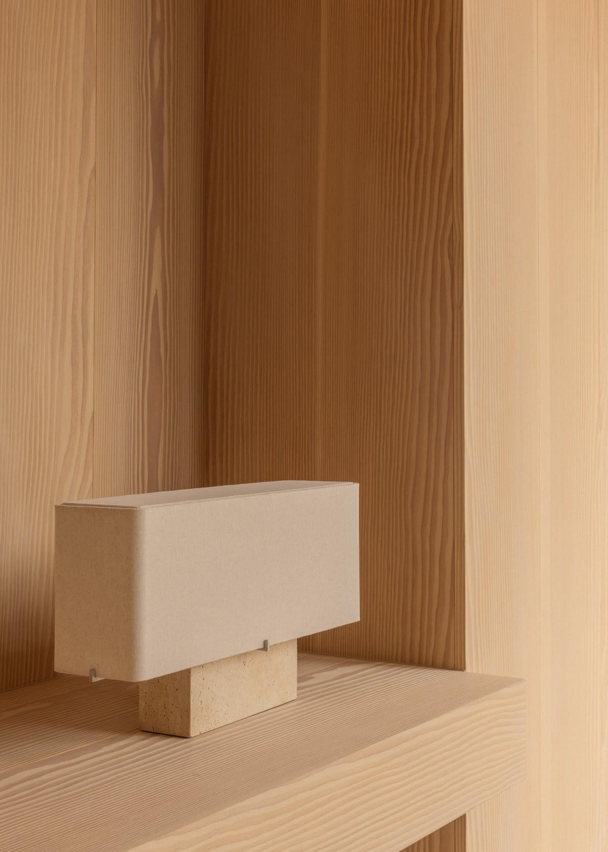 The Nonna Table Lamp in travertine balances sculptural presence with understated elegance, offering a modern yet familiar interpretation of timeless design. Anchored by a warm travertine base and paired with a softly diffused sand-colored shade,