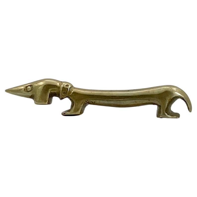 Vintage Brass Dachshund Dog Bottle Opener Bosse Vienna, Austria.

Classic early 1950s Austrian bottle opener, attributed to be designed by Ludwig Bemelmans showing 