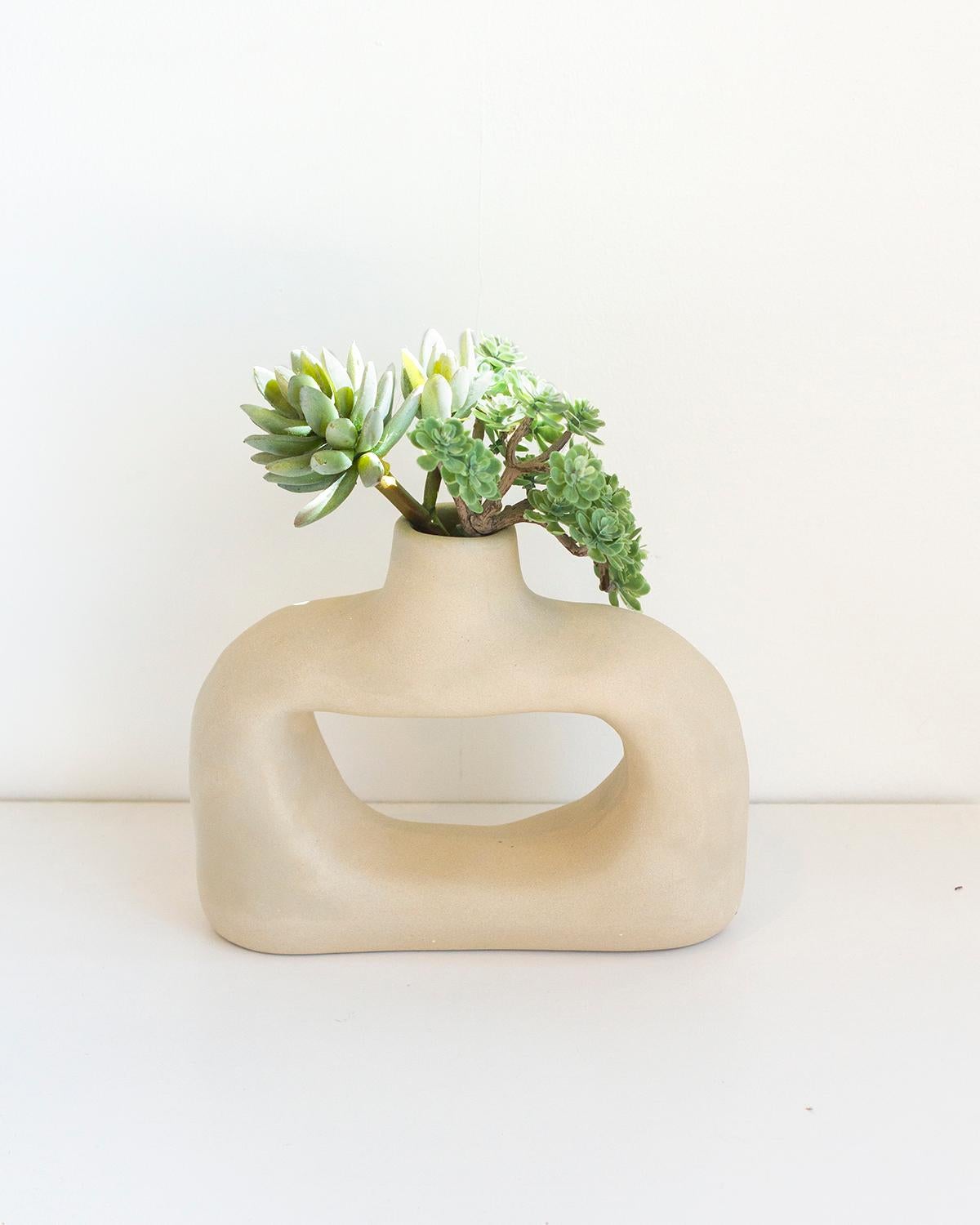 This Nook Clay Vase is a timeless piece crafted with natural white clay. Handmade from natural materials with a rustic and sculptural shape, it offers an organic modern look that embodies a minimalist and quiet luxury aesthetic perfect for any home