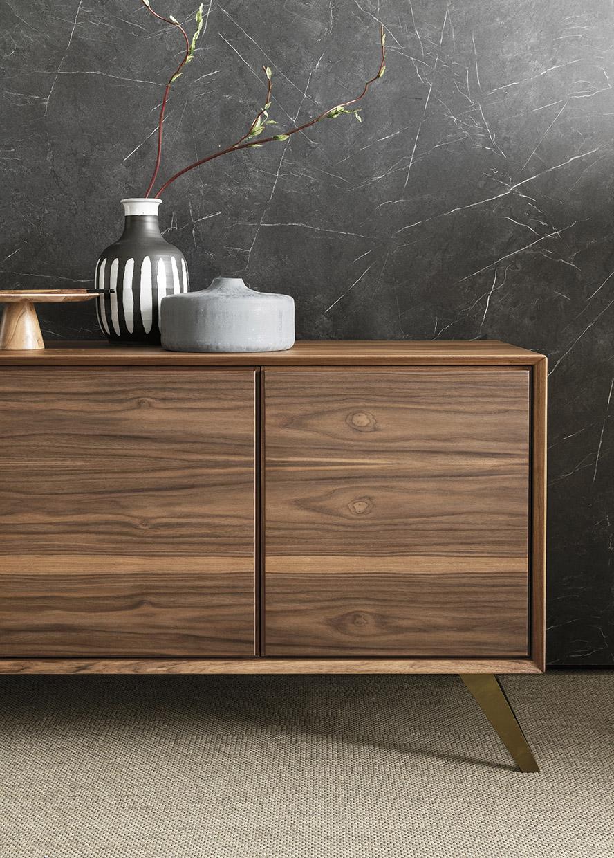 Nook is a contemporary sideboard that merges an essential design with bold Italian craftsmanship. Distinctive metal feet deliver sleek linear modernism to a wood body that can be configured with several combinations of doors and drawers. 

The