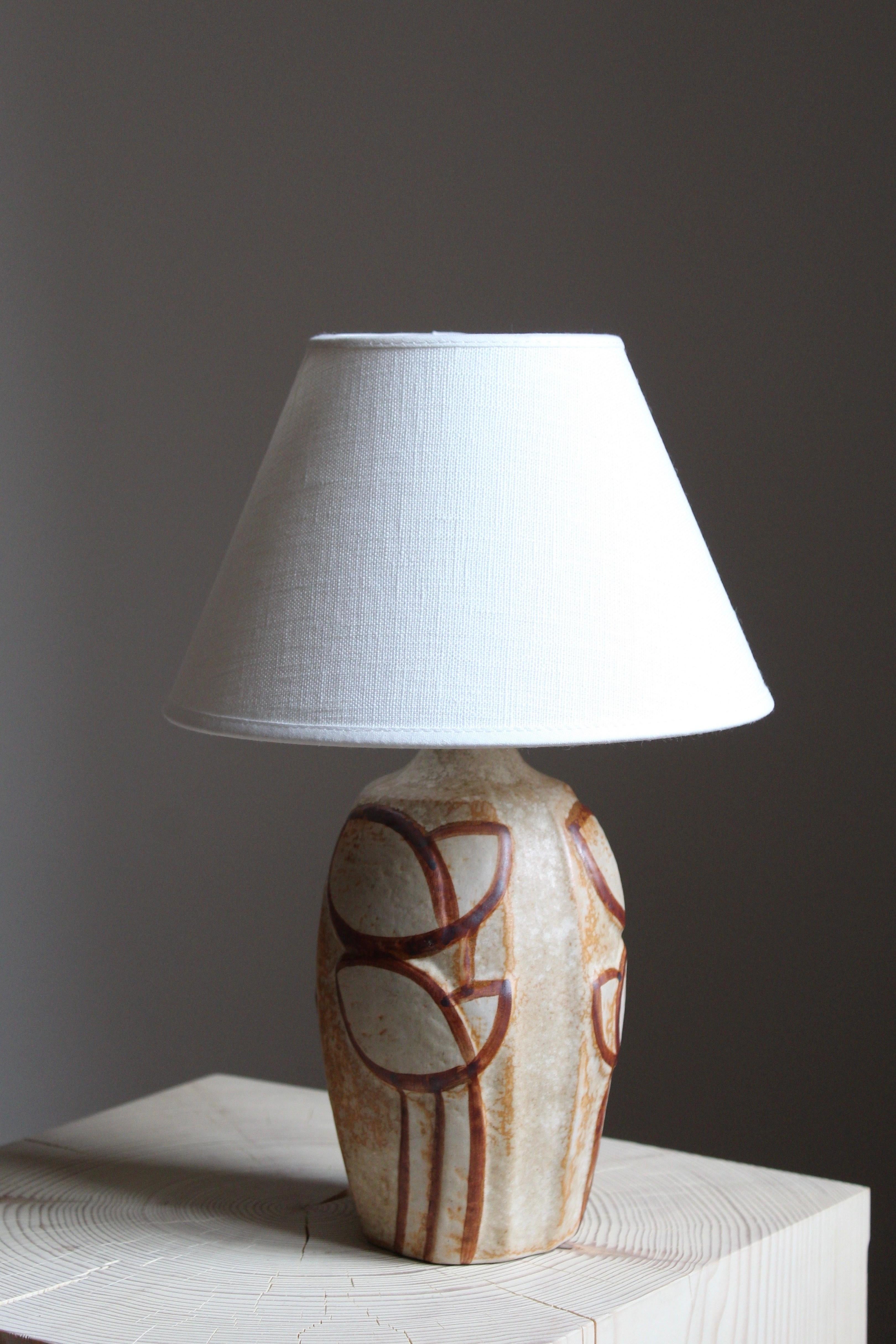 A small table lamp produced by Søholm Keramik, located on the island of Bornholm in Denmark. Design by Noomi Backhausen, signed. Sold without lampshade.

Glaze features brown-grey colors.

 