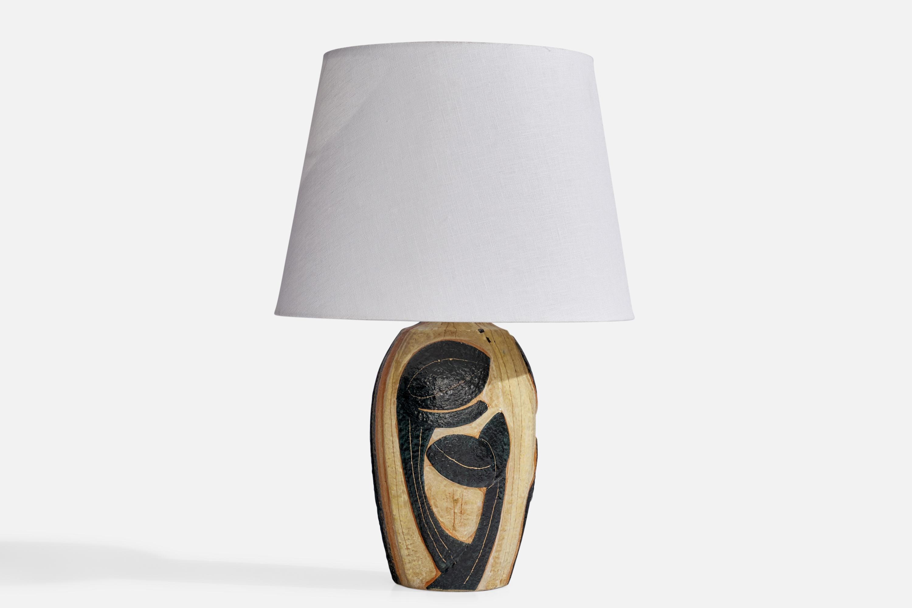 A beige and black-glazed stoneware table lamp with relief decoration, designed by Noomi Backhausen and produced by Søholm, Bornholm, Denmark, 1960s.

Dimensions of Lamp (inches): 12.3” H x 5.5” Diameter
Dimensions of Shade (inches): 9” Top Diameter
