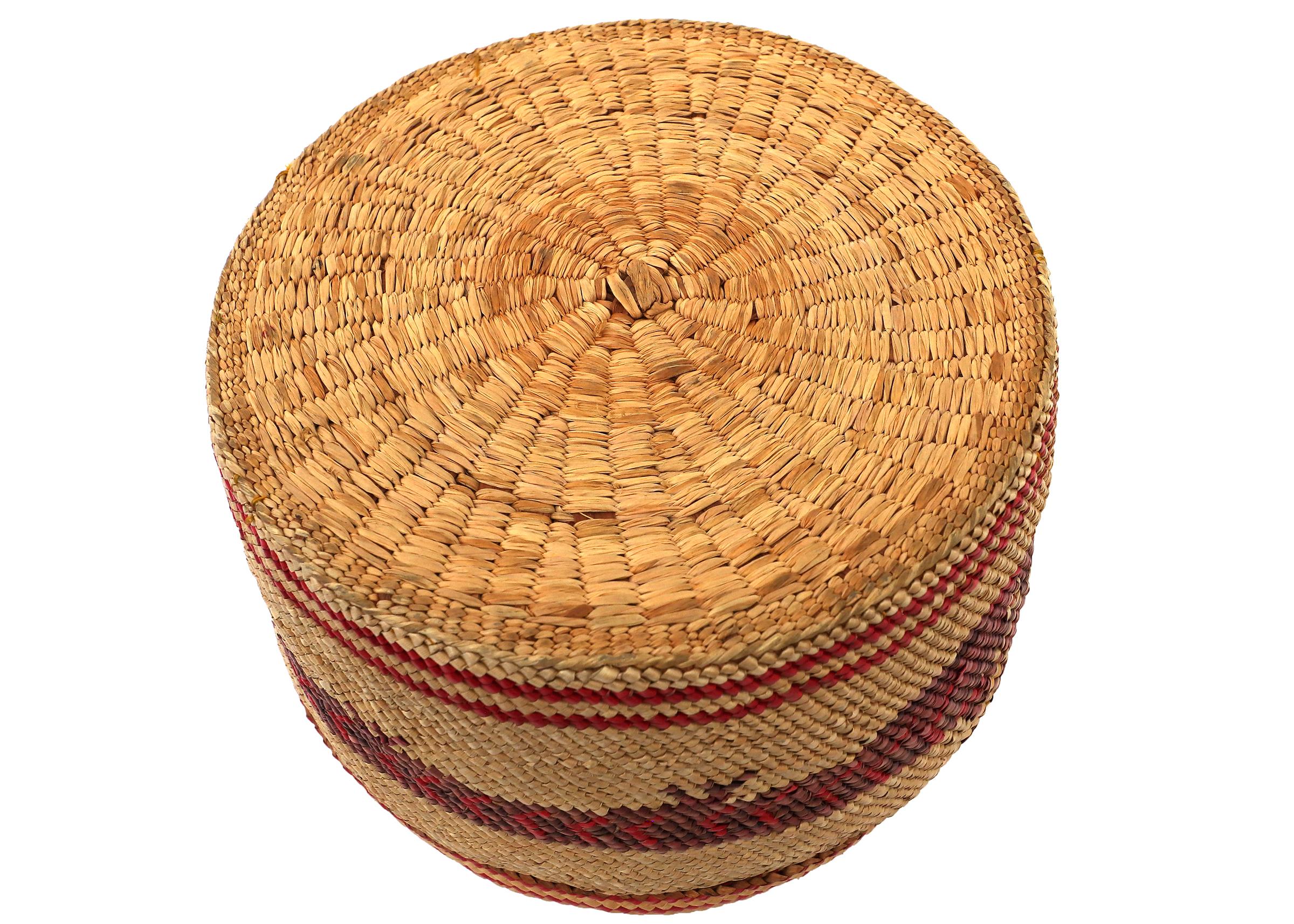 Northwest coast lidded basket from the Nootka tribe circa 1900 with a red sea wolf design. Measures 3 ½ x 5 ½ inches.