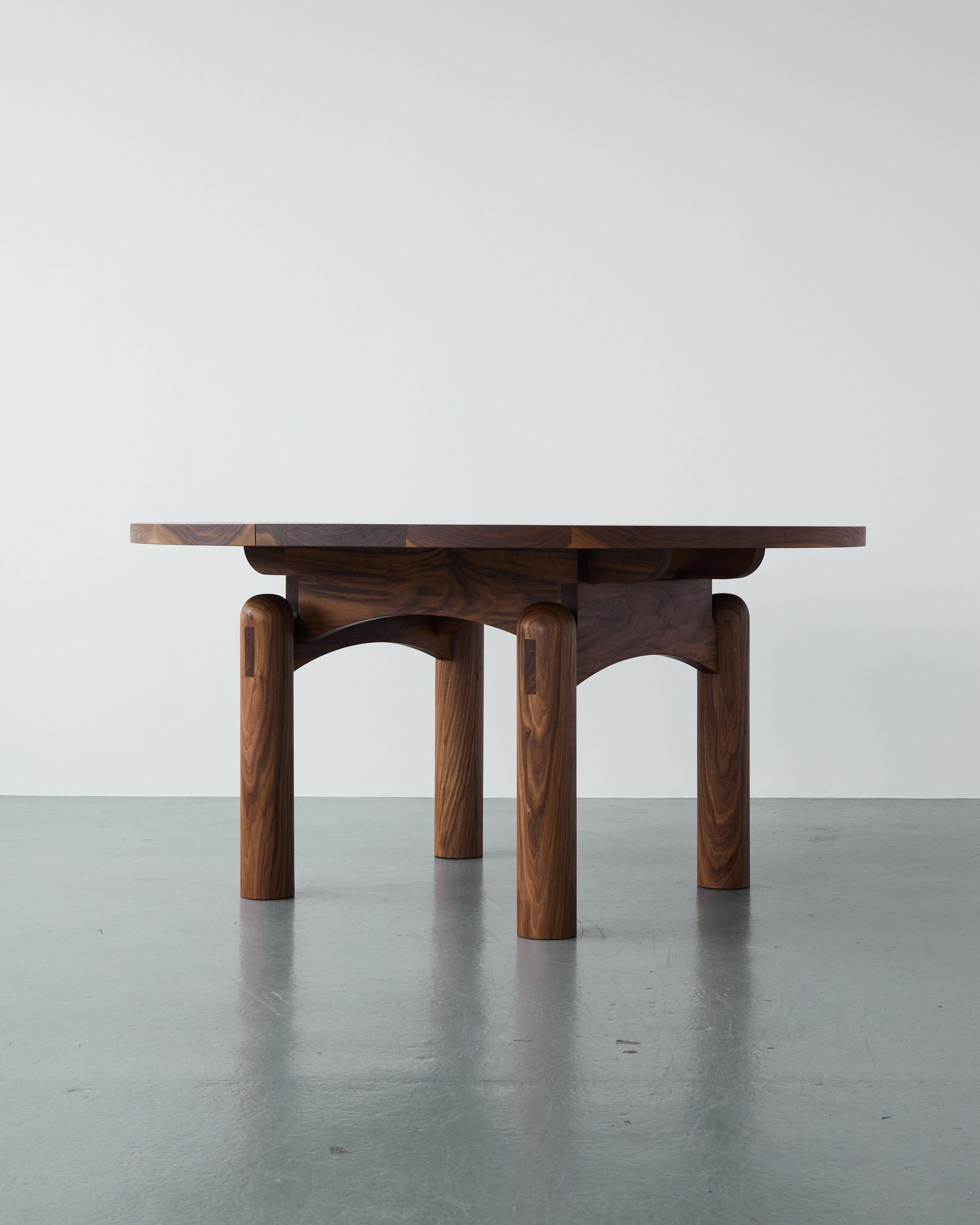 The Nora Dining Table is a sculptural, round table, whose volume and presence ground any dining room. The solid legs are topped with a dome, creating an arched silhouette from any angle and provide a tactile point of interest, which highlights the