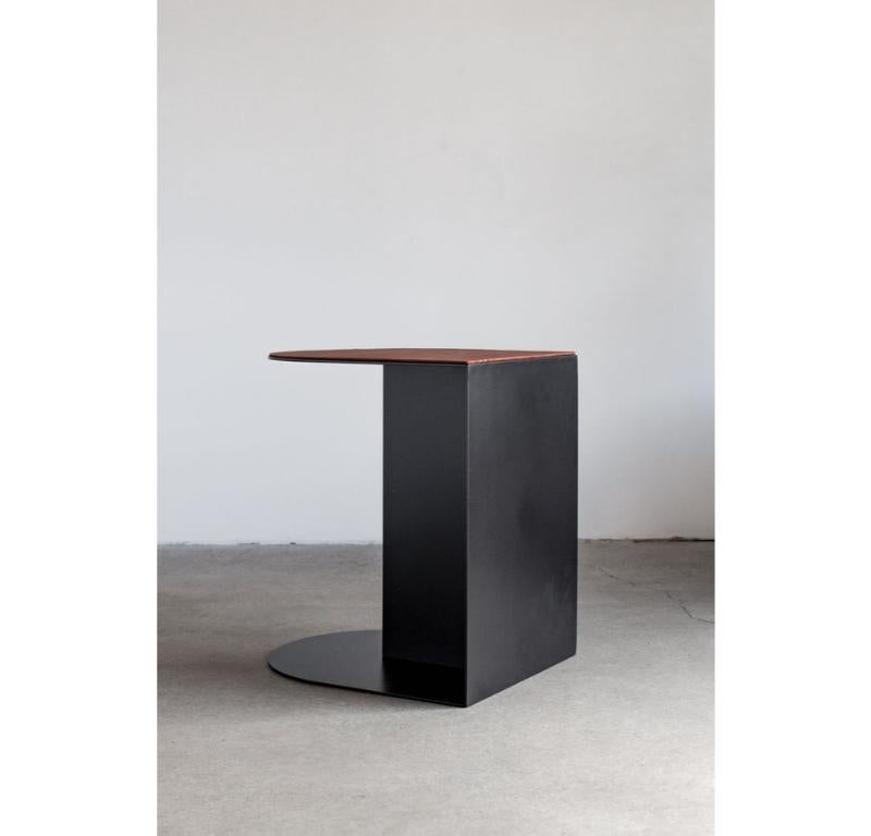 The Norah Accent Table offers a unique blend of form and functionality, featuring a steel body with a half-pill shaped top and base that softens the clean-lined profile of the piece. Two top options - leather, or steel - offer flexibility to suit