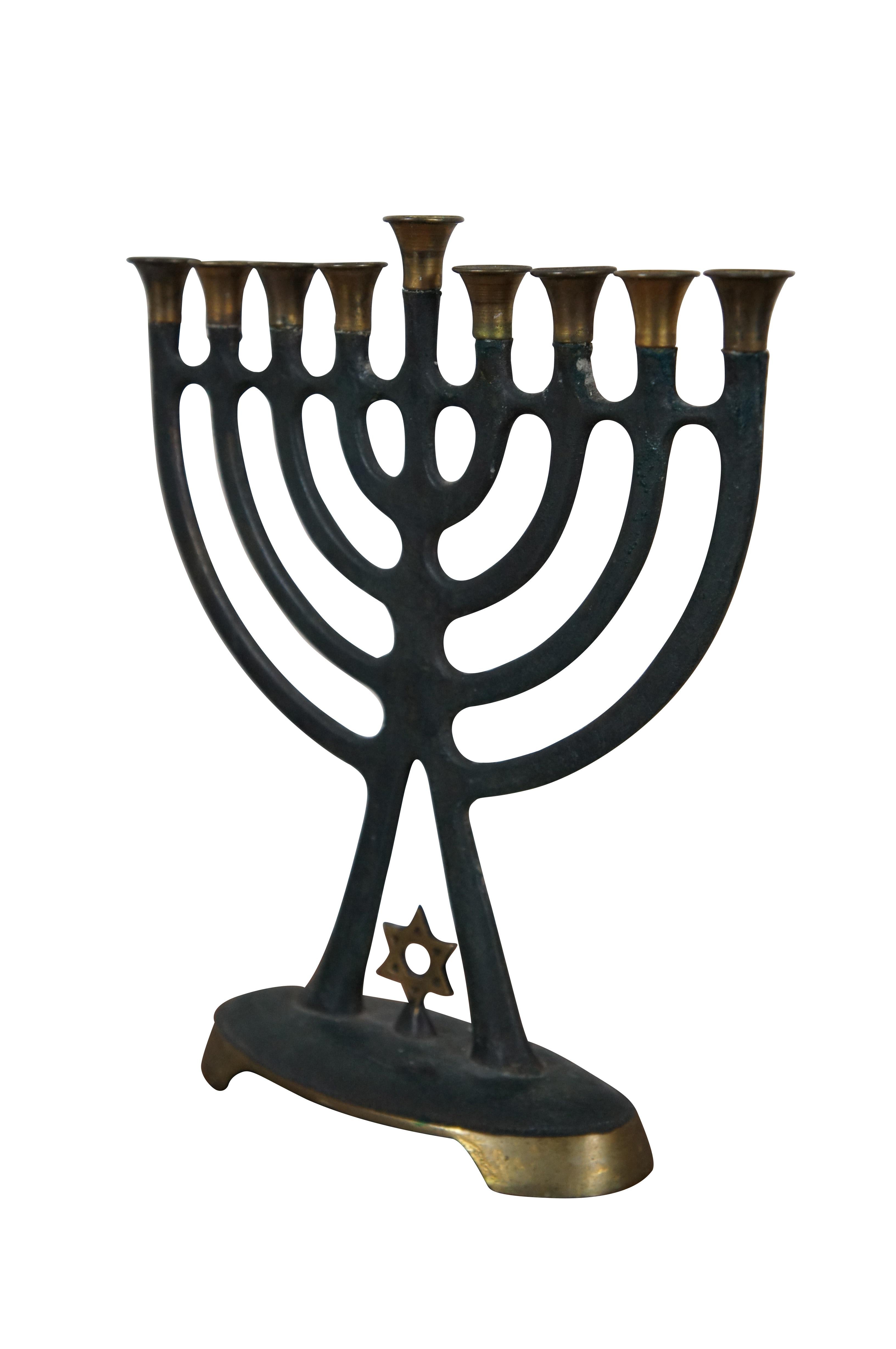 Mid Century Israeli Nordia Hannukka menorah featuring iron and brass construction with star of David.  Made in Israel.


