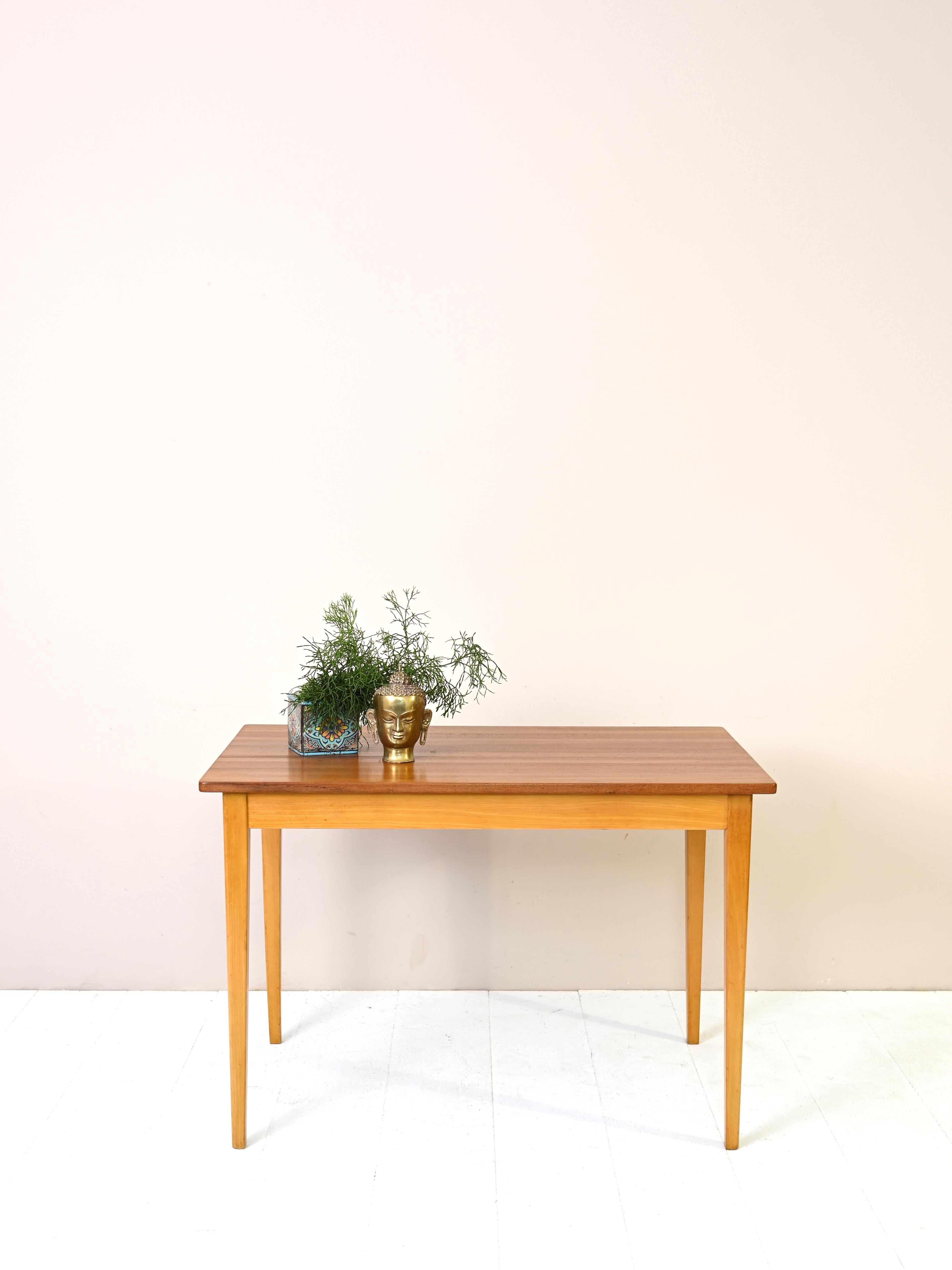 Rectangular dining table, original 1960s.
 
Featuring simple, minimalist shapes this vintage Scandinavian teak wood table is perfect for a small room.

It features long tapered legs, typical of Nordic design.

Good condition. It has been restored to