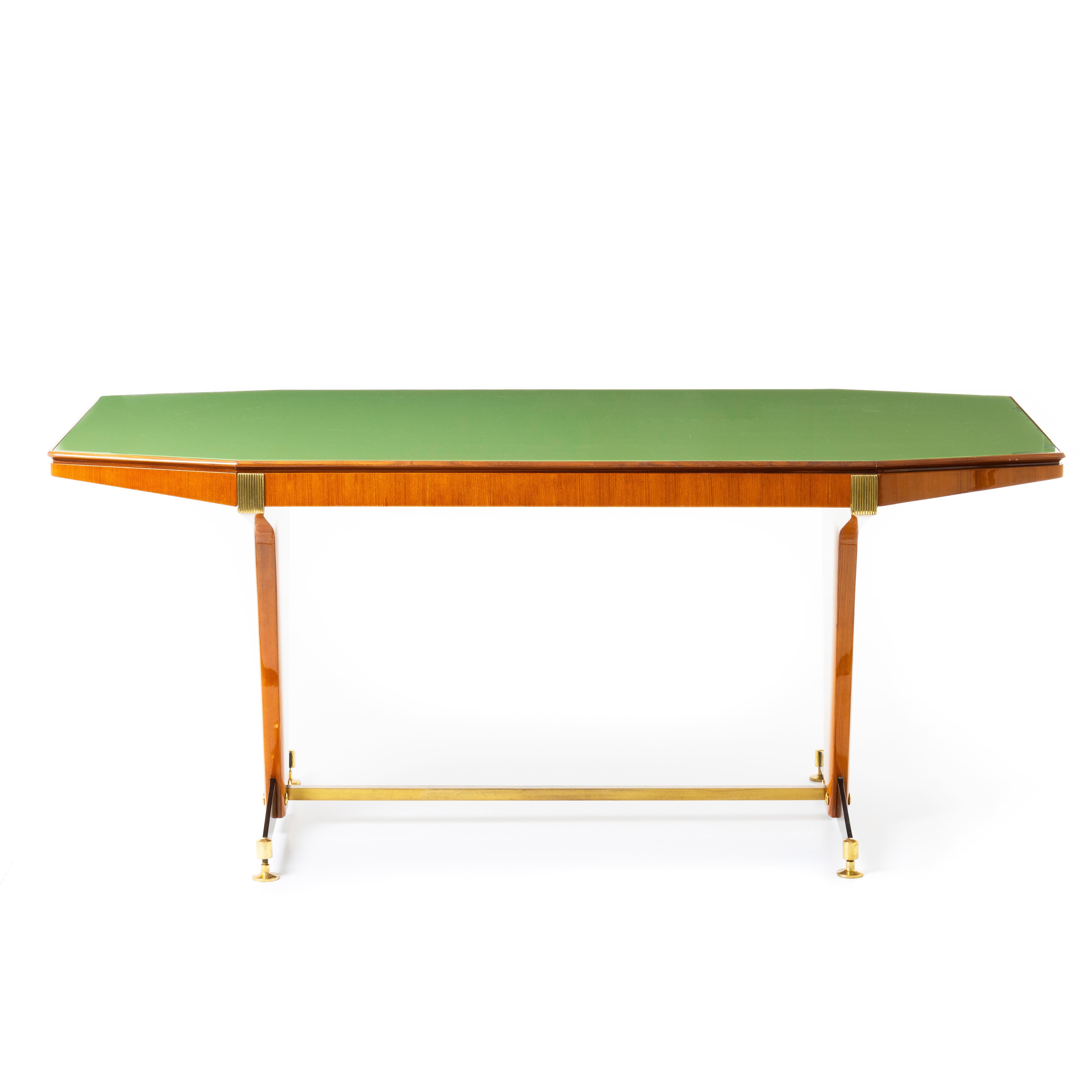 Crafted from rich wood, this table exudes warmth and character, while its sleek lines and minimalist silhouette capture the essence of mid-century modern aesthetics.
Itss exquisite tabletop is adorned with a lustrous green-toned glass surface that