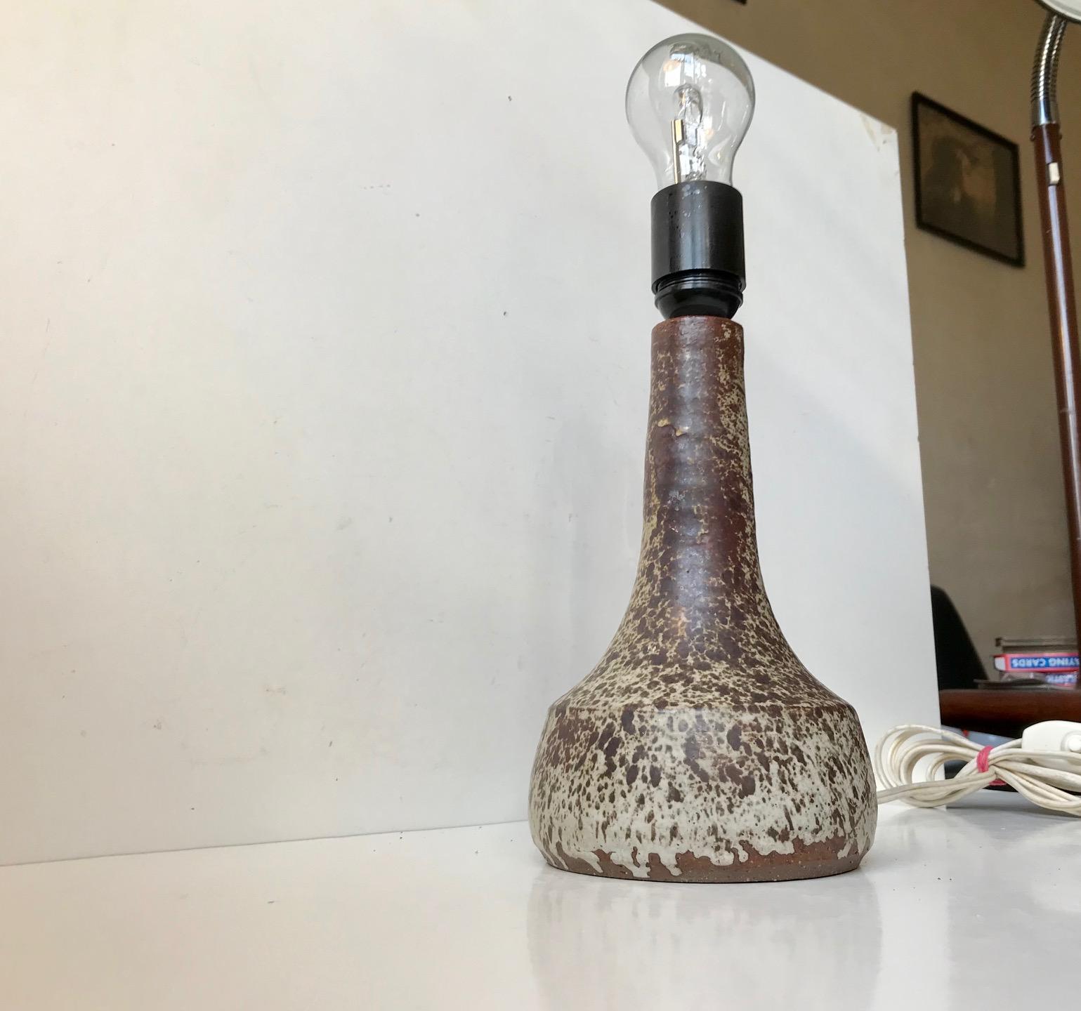 Unusually glazed ceramic table light decorated in earthy speckled glazes. It has no signature or markings but it was probably made by Knabstrup in Denmark during the 1960s who frequently used stickers during this period. The styling of this light is