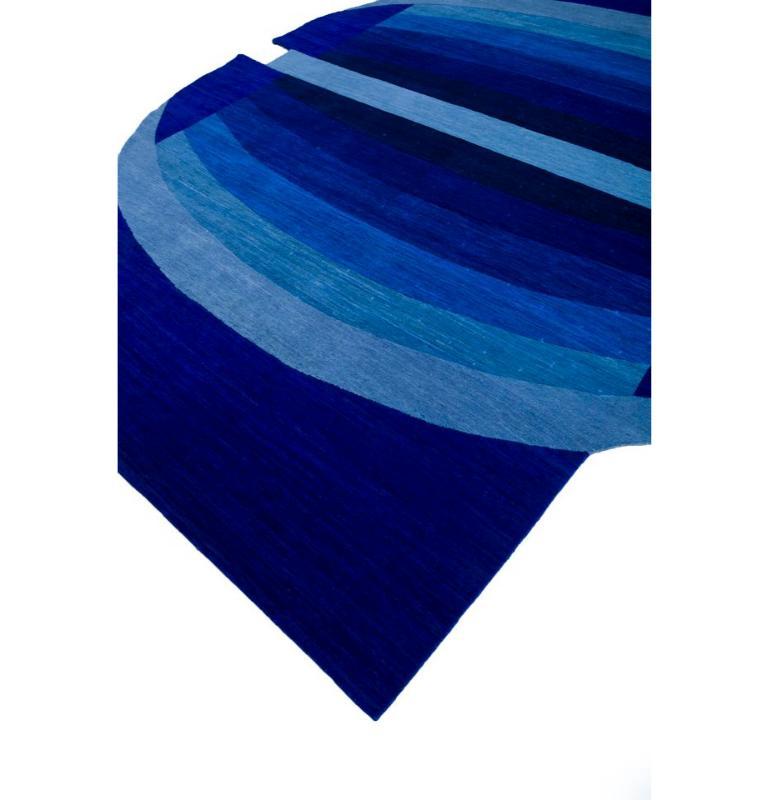 This rectangular hand knotted rug from our Brahmaand collection features a distinctive pattern in shades of blueberry, forming an intricate play of geometric shapes that adds a modern touch to your home decor. The blueberry color palette, with its