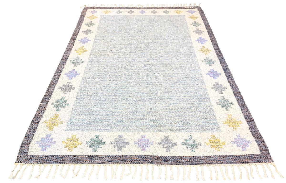 Invigorate your home space with the Swedish Rollakan Rug! This simple yet eye-catching Scandinavian design features a soft color palette, and is crafted using traditional flat weaving techniques. It's the perfect way to infuse warmth and comfort