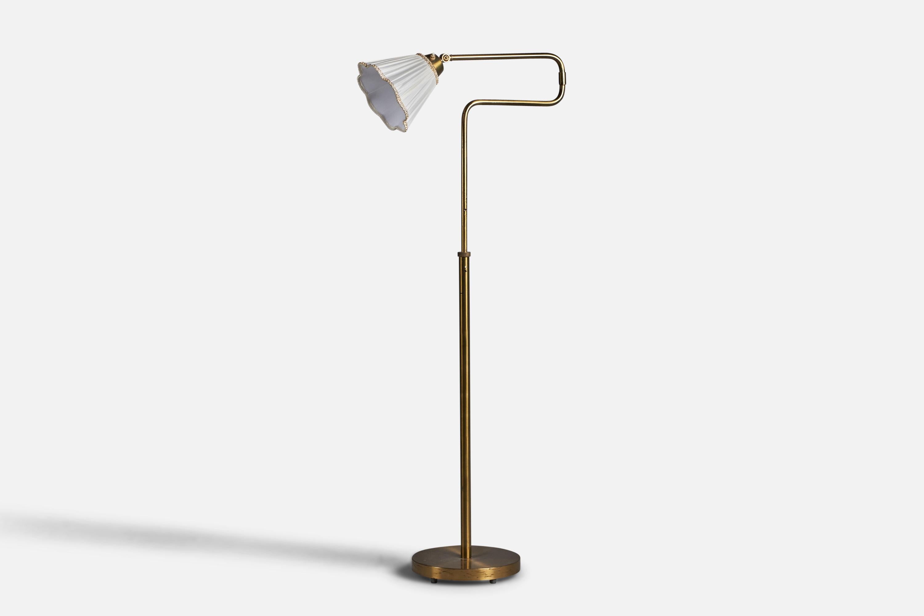 An adjustable brass and fabric floor lamp designed and produced by Nordiska Kompaniet, Sweden, 1940s.

Overall Dimensions (inches): 55.25” H x 11.5” W x 23.5” D
Dimensions variable. Adjustability of height fixed in to two positions, inquire for more