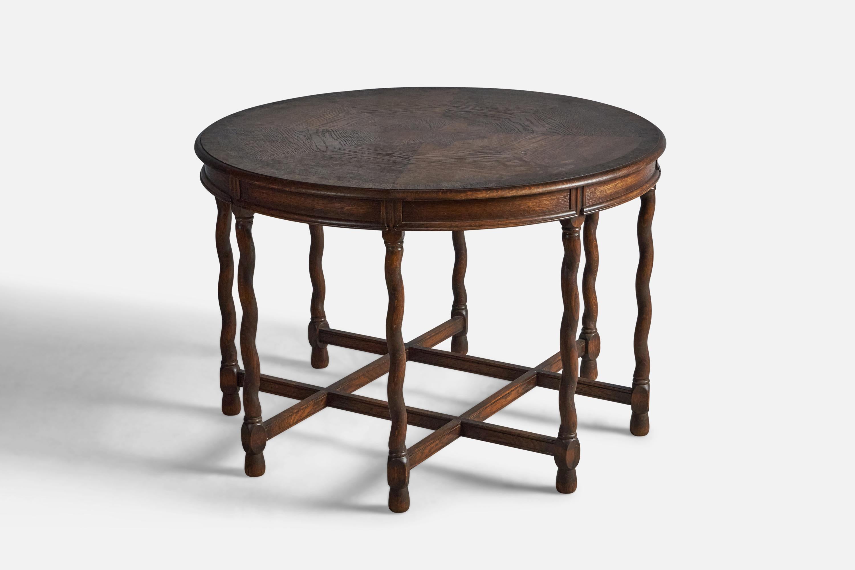 A dark-stained oak table with inlays and carved decoration, designed and produced by Nordiska Kompaniet, c. 1930s.