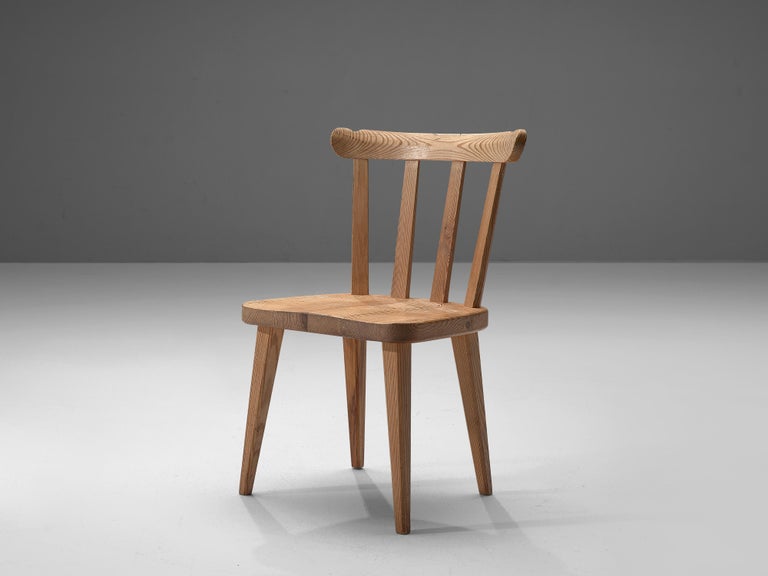 Nordiska Kompaniet, dining chair 'Ekerö, pine, Sweden 1930s. 

Elegant dining chair executed in northern European pinewood. The design is simplistic; four tapered legs, solid seating and spindel or slat back. These chairs have a modest and natural