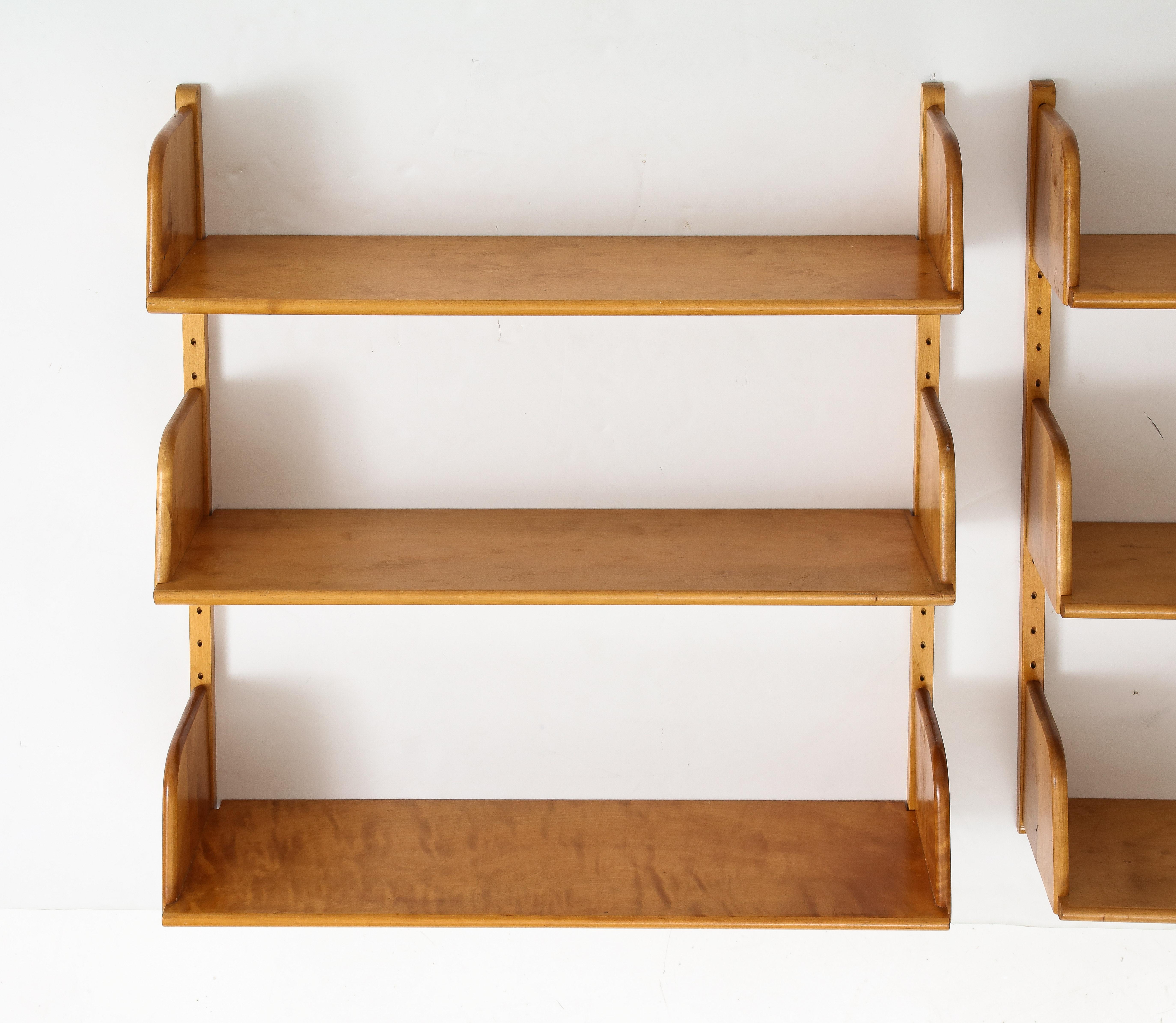 Two Swedish Nordiska Kompaniet birch wood wall shelves, Circa 1940s, Adjustable shelves. Solid Birch shelves, adjustable, mounted to the wall with birch brackets with holes. Stamped. Measurements are for each shelf.