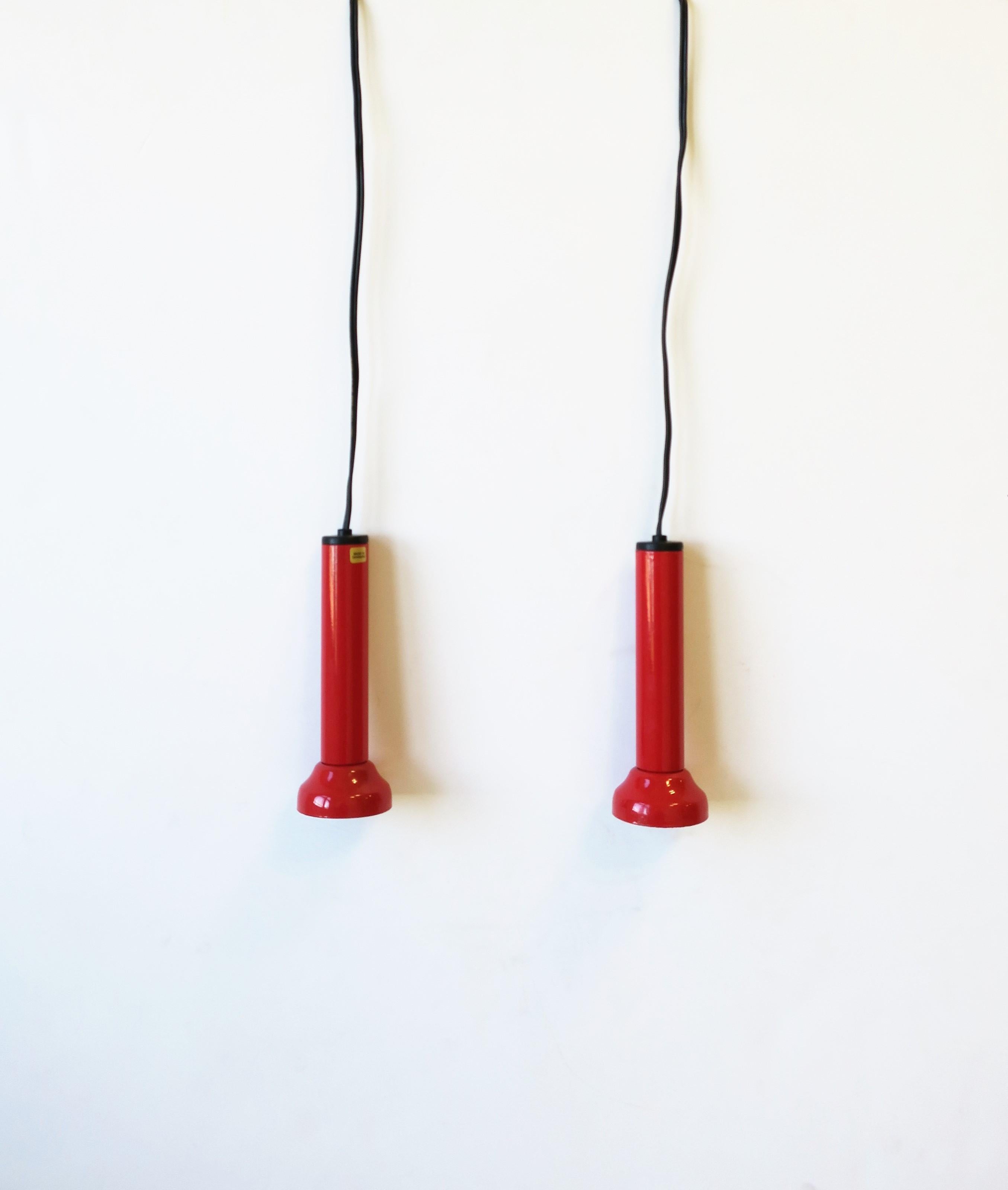 A pair/set of two (2) Danish Postmodern pendant lights in red gloss enamel by NordLux, circa late-20th century, Denmark. Each are marked 