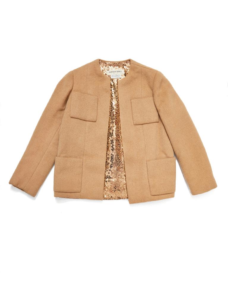 Norman Norell, camel hair, wool, collarless jacket having 4 patch pockets
Two at the bust, and 2 at the hip. Interior of the jacket is encrusted with gold tone tiny paillettes. Jacket ends just below the hip. No closures.