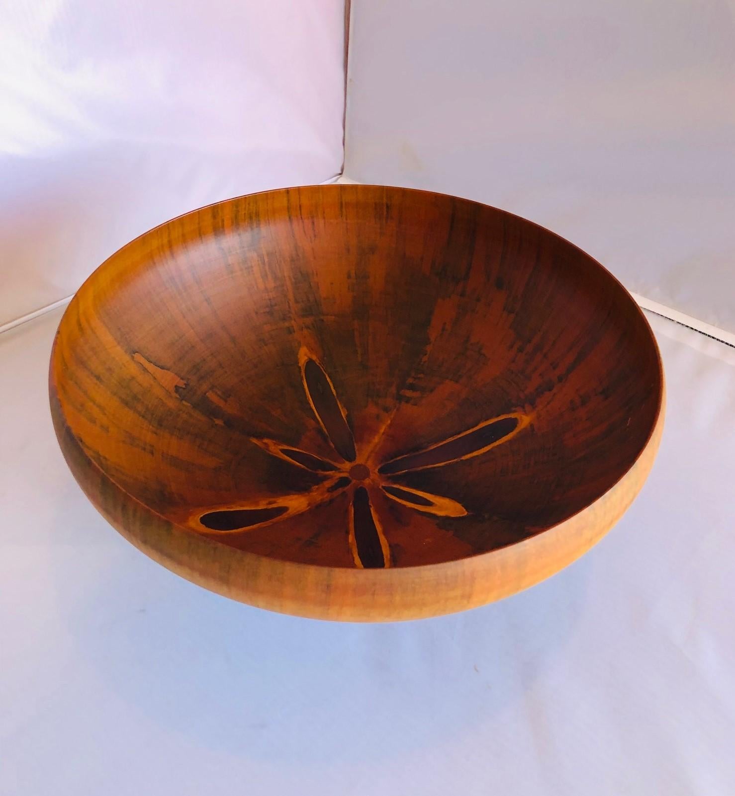 Unique and beautiful Norfolk Island pine bowl by Gene Bickerstaff, circa 1998. The bowl has a translucent effect to it which is created by soaking the wood in orange oil for weeks prior to turning it.