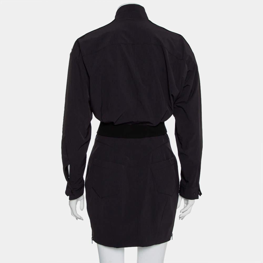 Dieses Kleid von Norisol Ferrari spiegelt die neuesten Modetrends wider. Dieses schwarze Kleid ist die perfekte Wahl für jeden Freizeitausflug. Das aus hochwertigen Stoffen gefertigte Kleid hat eine einzigartige Silhouette und ist mit einem Gürtel