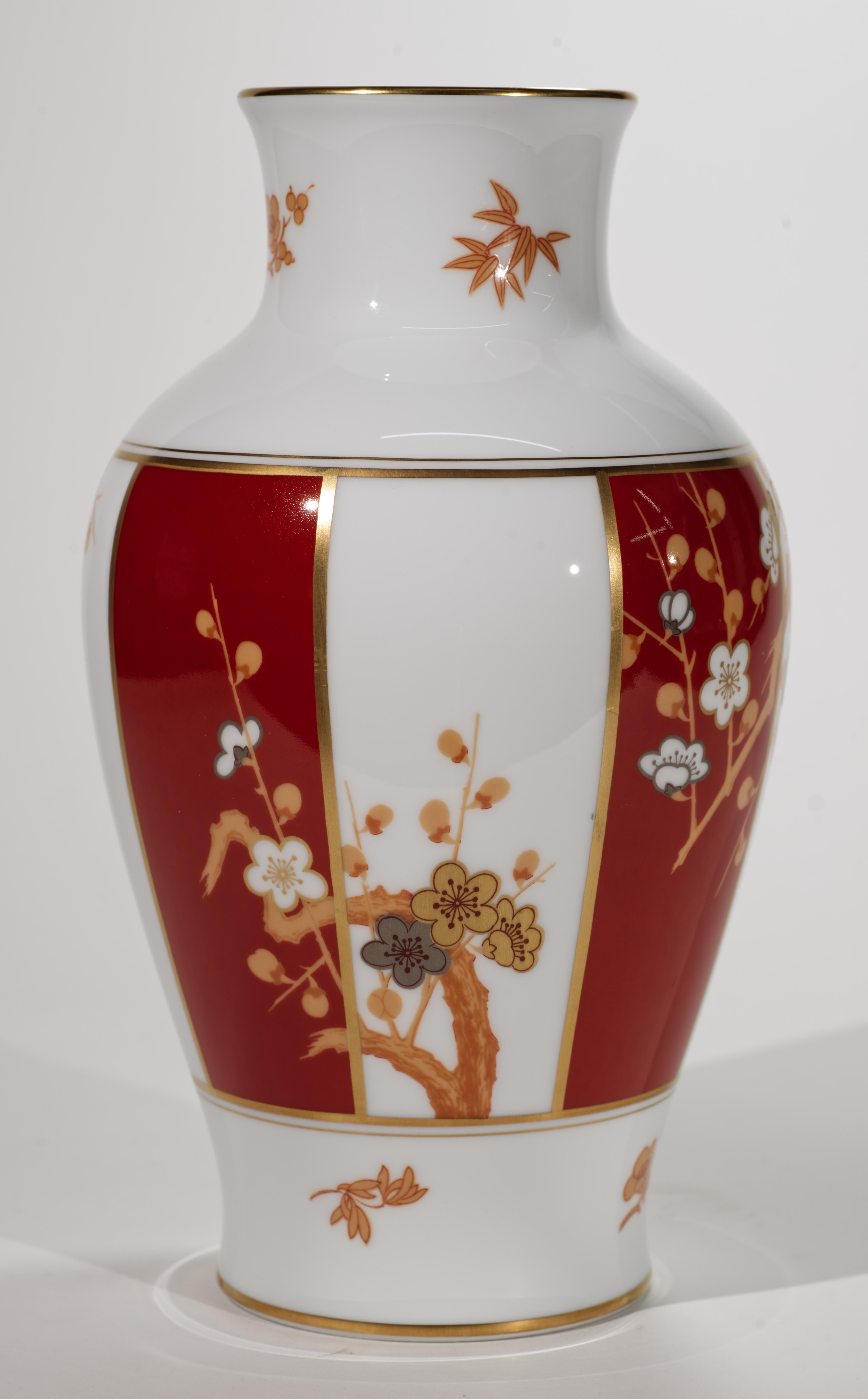 
Il vaso vintage in porcellana fine presenta il tradizionale decoro Sakura in giallo, oro e platino su sfondo rosso e bianco; il bordo e la base sono accentuati da bande dorate. Il vaso è contrassegnato sul fondo con 