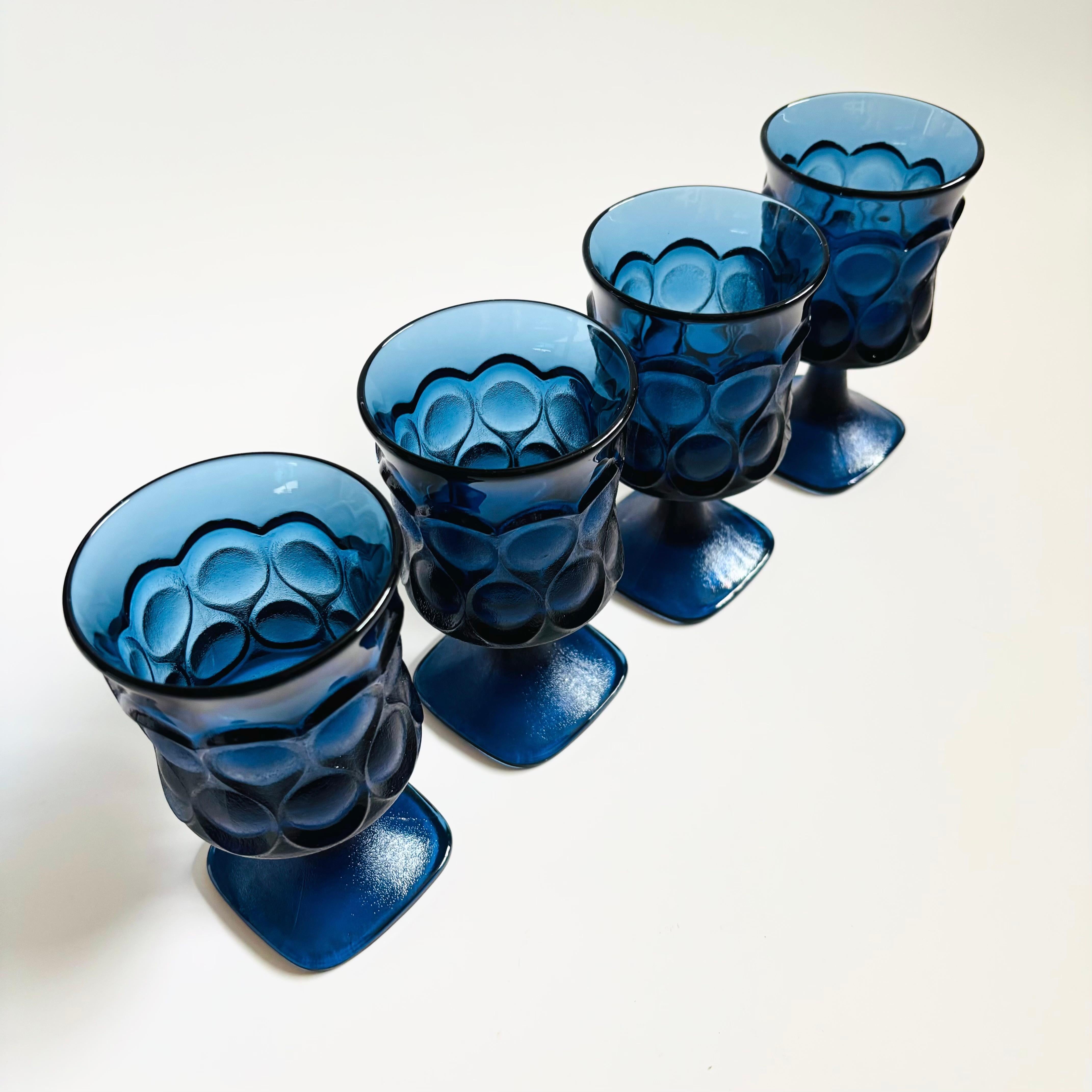 A set of 4 vintage large goblets in beautiful dark blue glass. Lovely textured ornate pattern to the exterior with smooth interiors. Made in the 