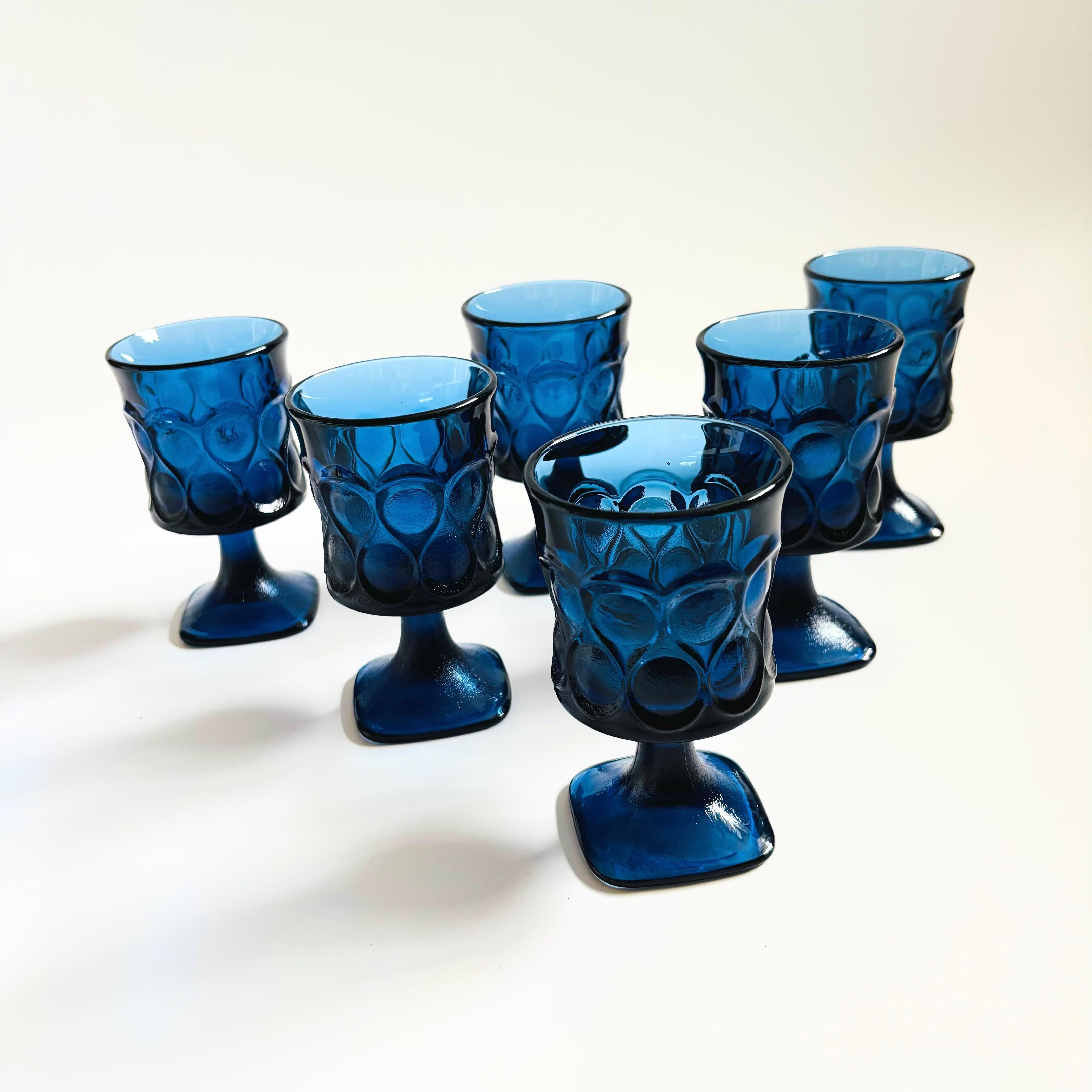 A set of 6 vintage wine goblets in beautiful dark blue glass. Lovely textured ornate pattern to the exterior with smooth interiors. Made in the 
