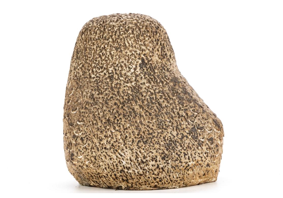 A large textured brown and beige pottery owl sculpture with a great mid-century look, having pierced eyes and signed on the bottom. With a hole in the base for attachment to a mount. The noted CT artist was in residence at the Silvermine Guild in