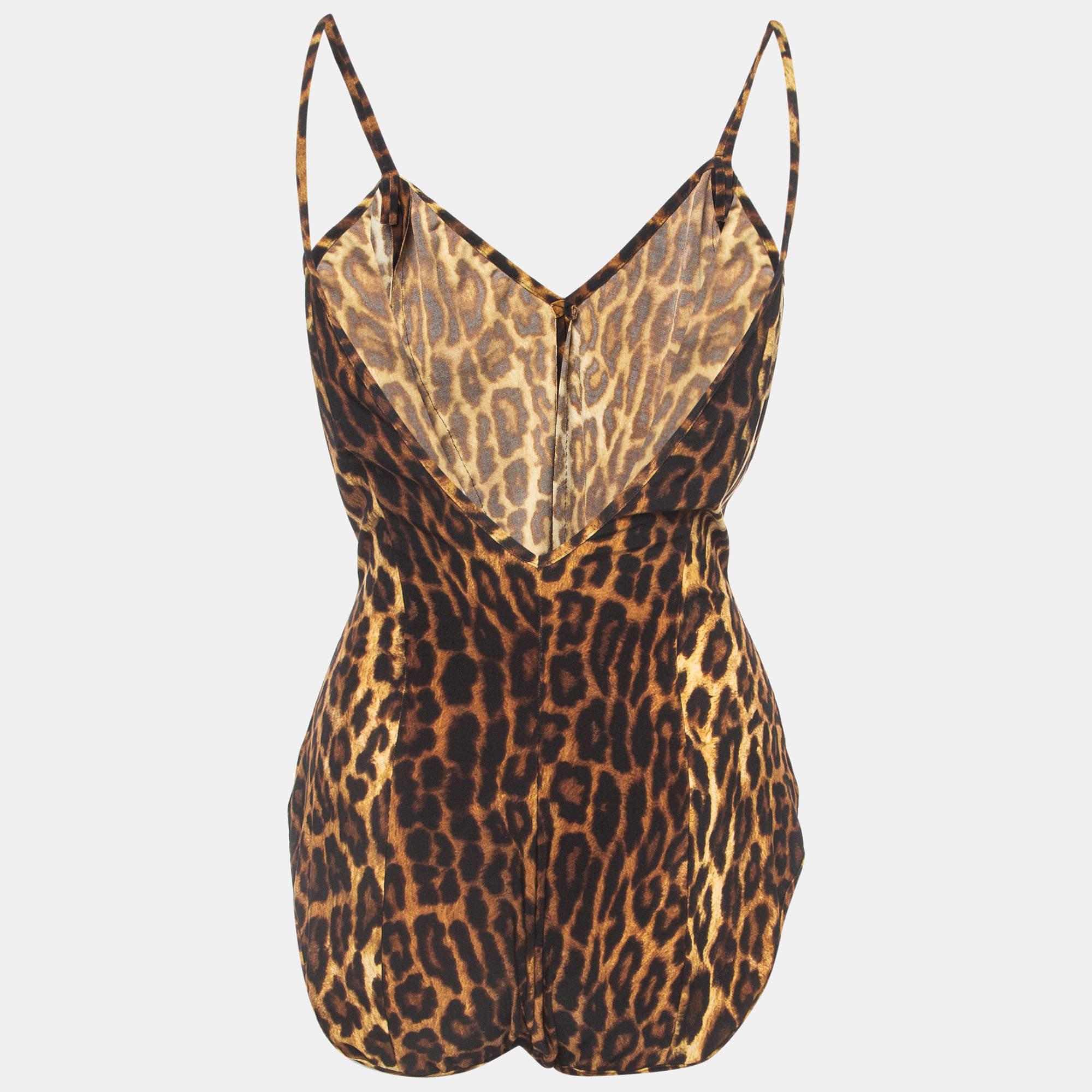 The Norma Kamali swimsuit is a stylish one piece featuring a bold leopard print. With a strappy design it combines glamour with a hint of superhero inspiration making a bold statement at the beach or pool.