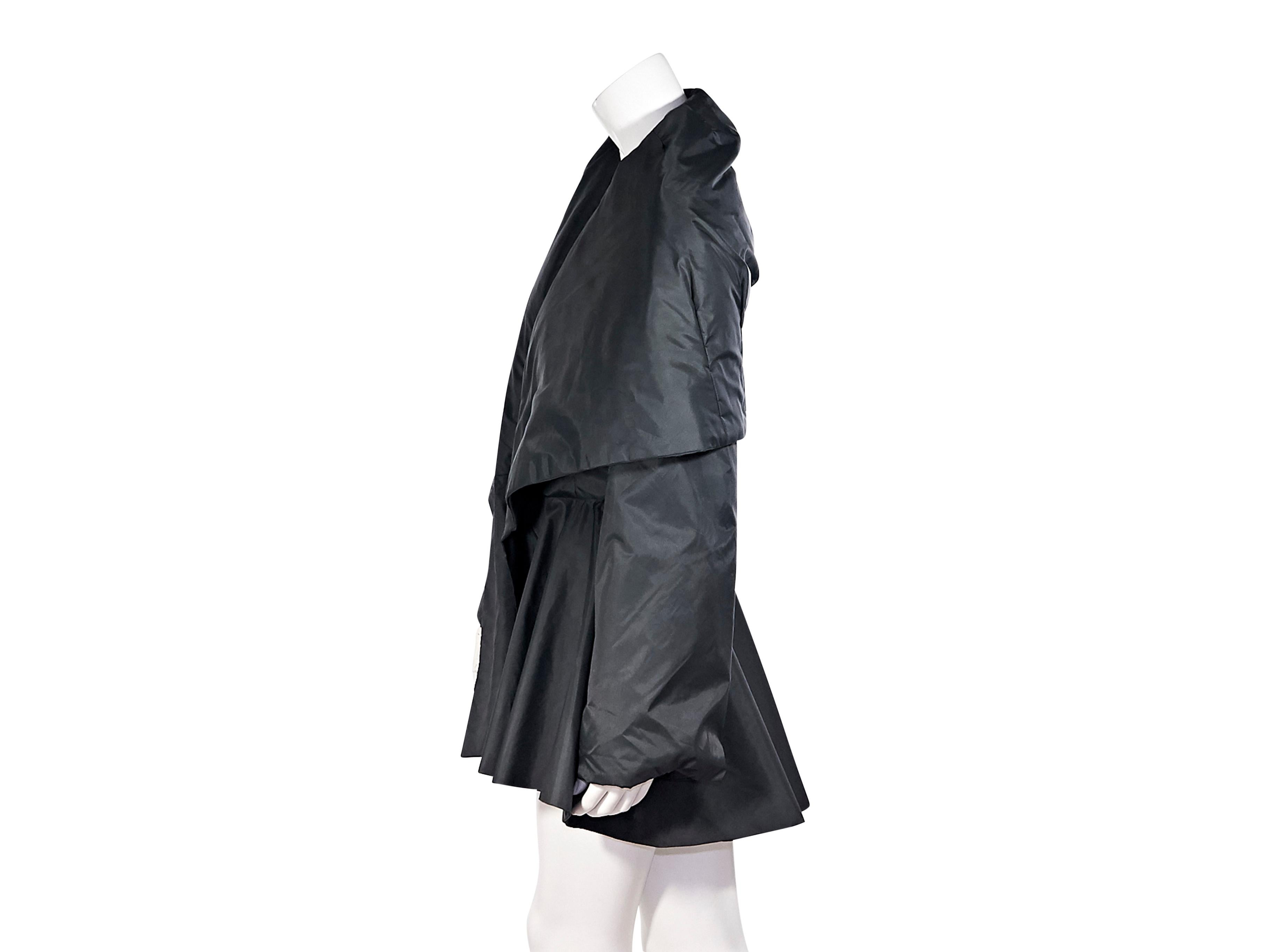 Product details:  Vintage black peplum coat by Norma Kamali.  Oversized collar.  Long sleeves.  Open front.  Peplum waist.  42