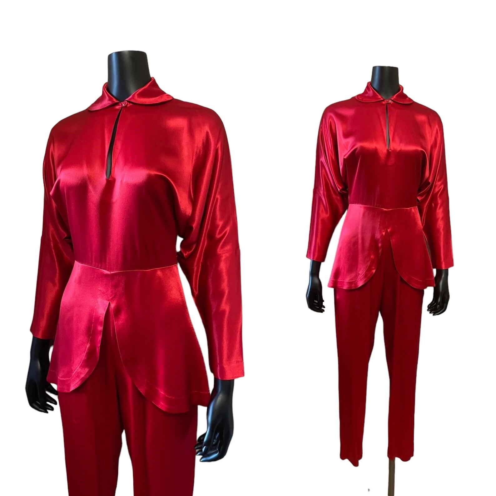 Norma Kamali lipstick red jumpsuit
Drop shoulders, batwing long sleeves
Peter pan collar with button closure
Key hole neckline
Peplum waist
Tapered leg
Back zip closure

Circa 1980s
Norma Kamali
Made in USA
Tagged Size 4
Red
Satin 
Excellent