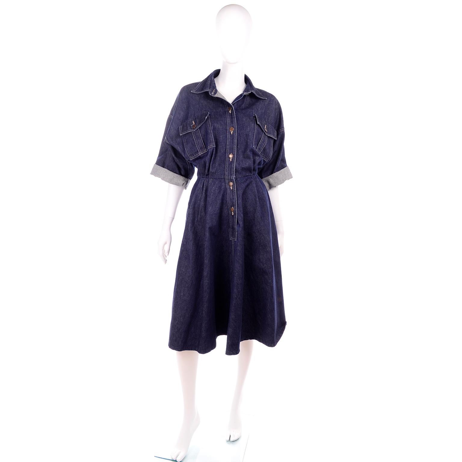 This is a wonderful vintage Norma Kamali dark denim dress from the 1980's. This oversized dress has drop shoulder seams, 3/4 sleeves, breast pockets with flaps and is pleated with a cinched waist (no stretch). The a-line full skirted portion has