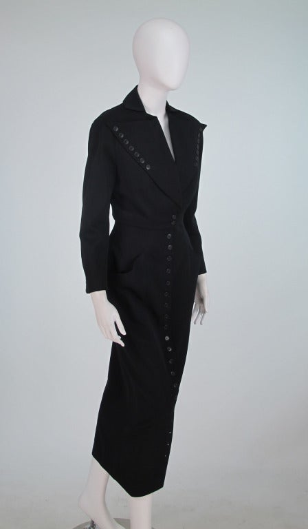 Norma Kamali OMO black button fitted suit from the 1980s. Sexy silhouette with a bit of military influence. Deep v front jacket with wide button detail lapels is fitted at the waist, long sleeves have button detail cuffs, jacket is fully lined. The