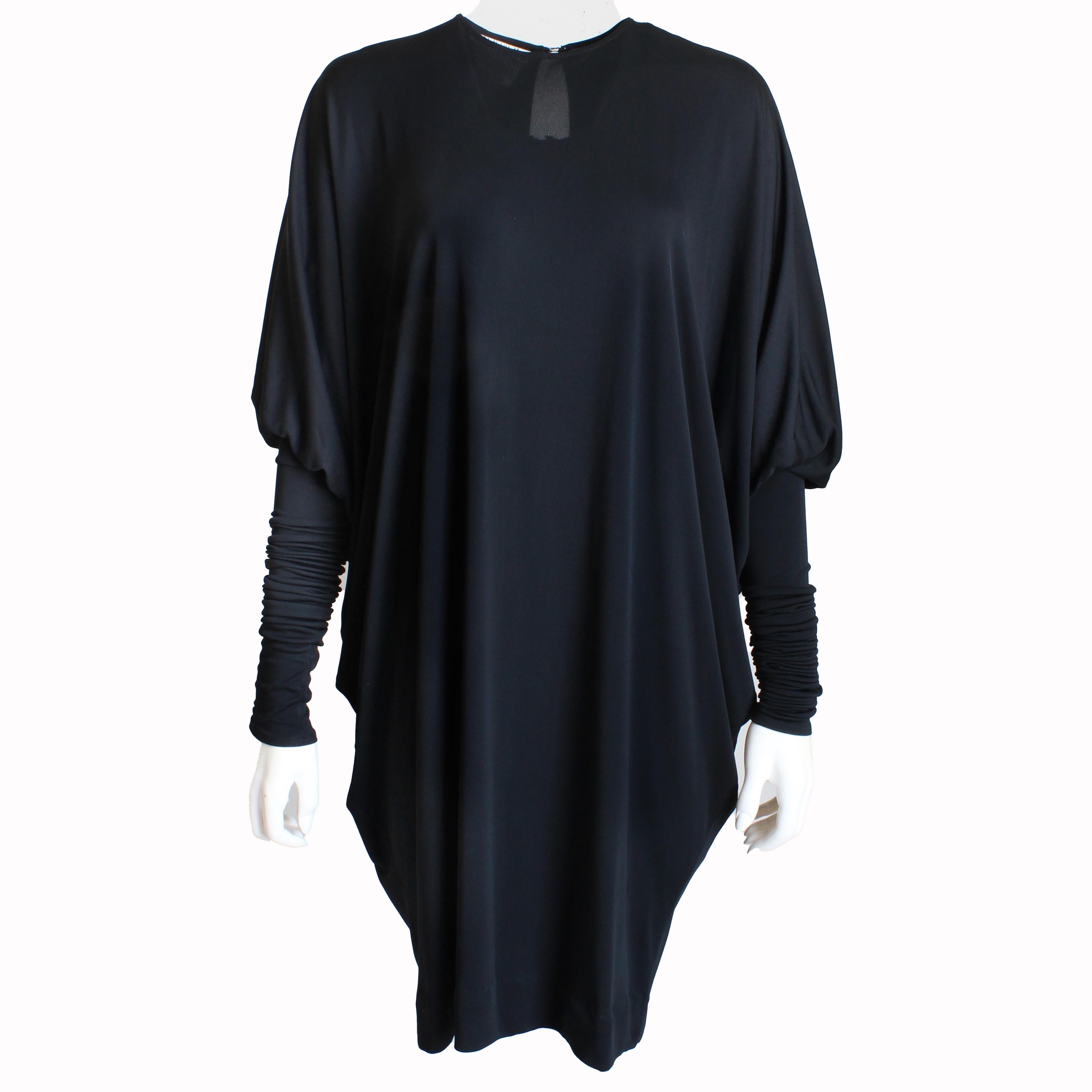 Preowned, vintage dress by the fabulous Norma Kamali, likely made in the 1980s.  Made from black crepe fabric (no content label), it features Dolman or batwing top sleeves and fitted stretchy tube sleeves that can be scrunched up or down to achieve