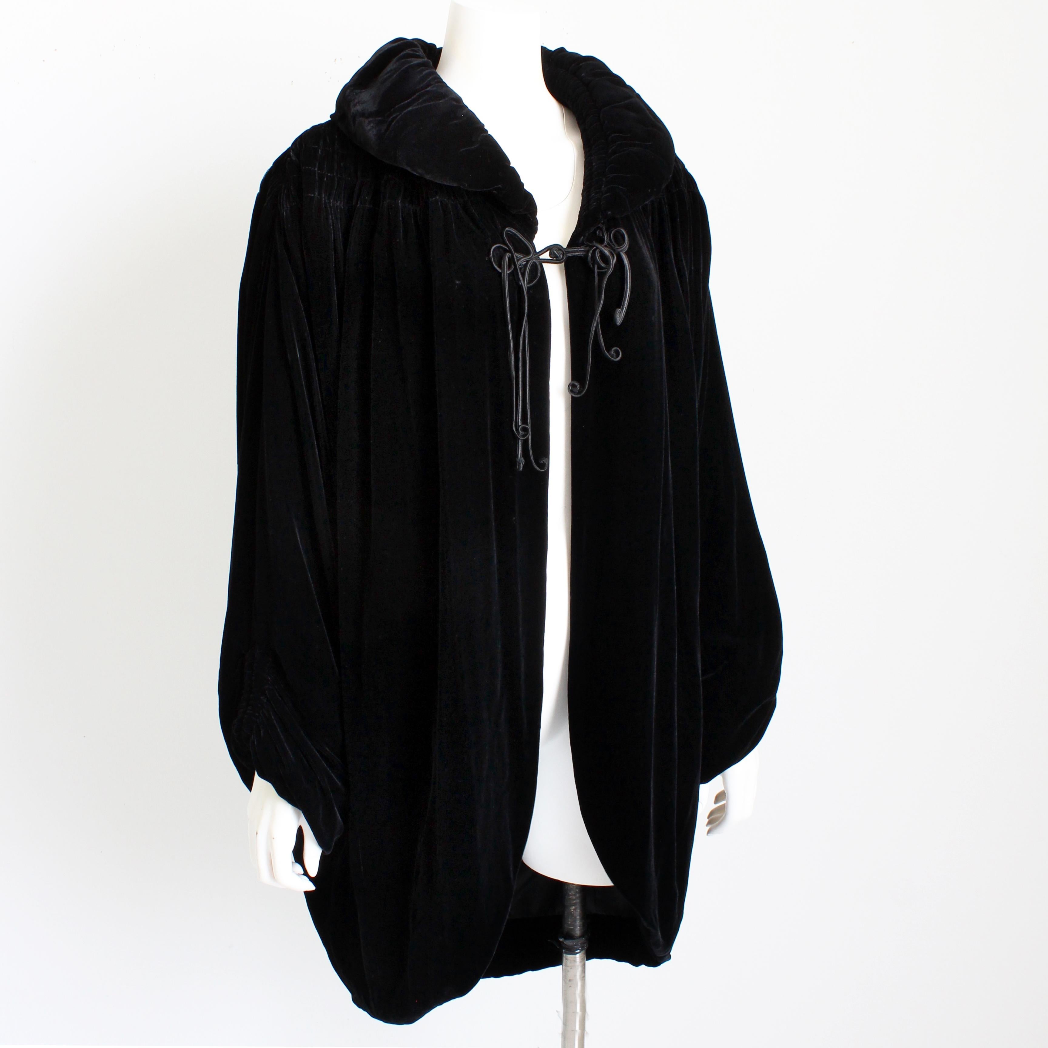 Preowned, vintage Norma Kamali OMO cocoon style jacket, likely made in the early 1990s.  Made from black silk/rayon blend velvet, this fabulous jacket features huge batwing sleeves with shirring at the yoke and sleeve bottoms.  It fastens with a