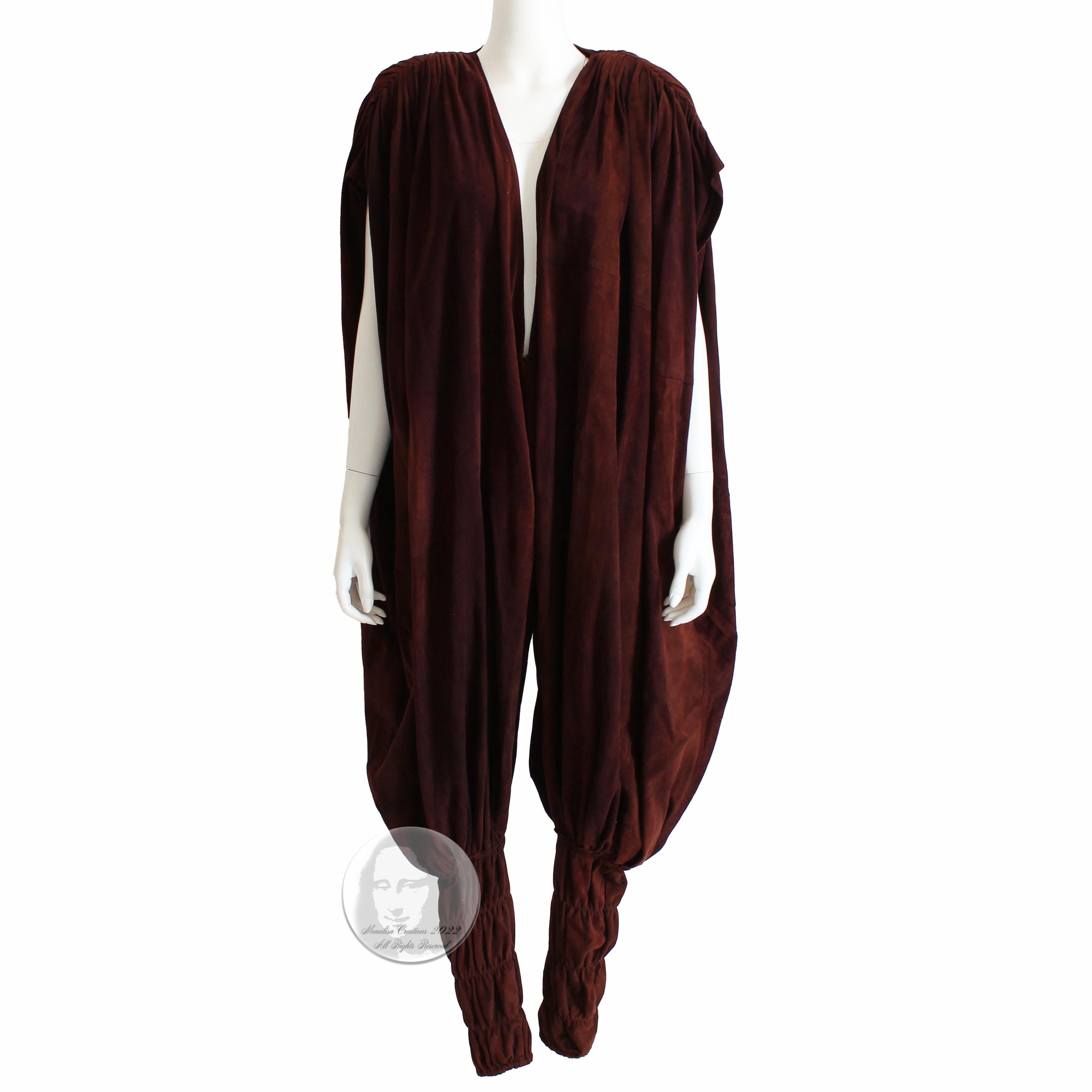 Authentic, preowned, vintage & RARE Norma Kamali OMO Suede Leather Draped Jumpsuit with Harem Pant, likely made in the late 70s. Made from wine-hued suede, it features a low cut top, balloon or harem-styled legs with elasticized bottoms and