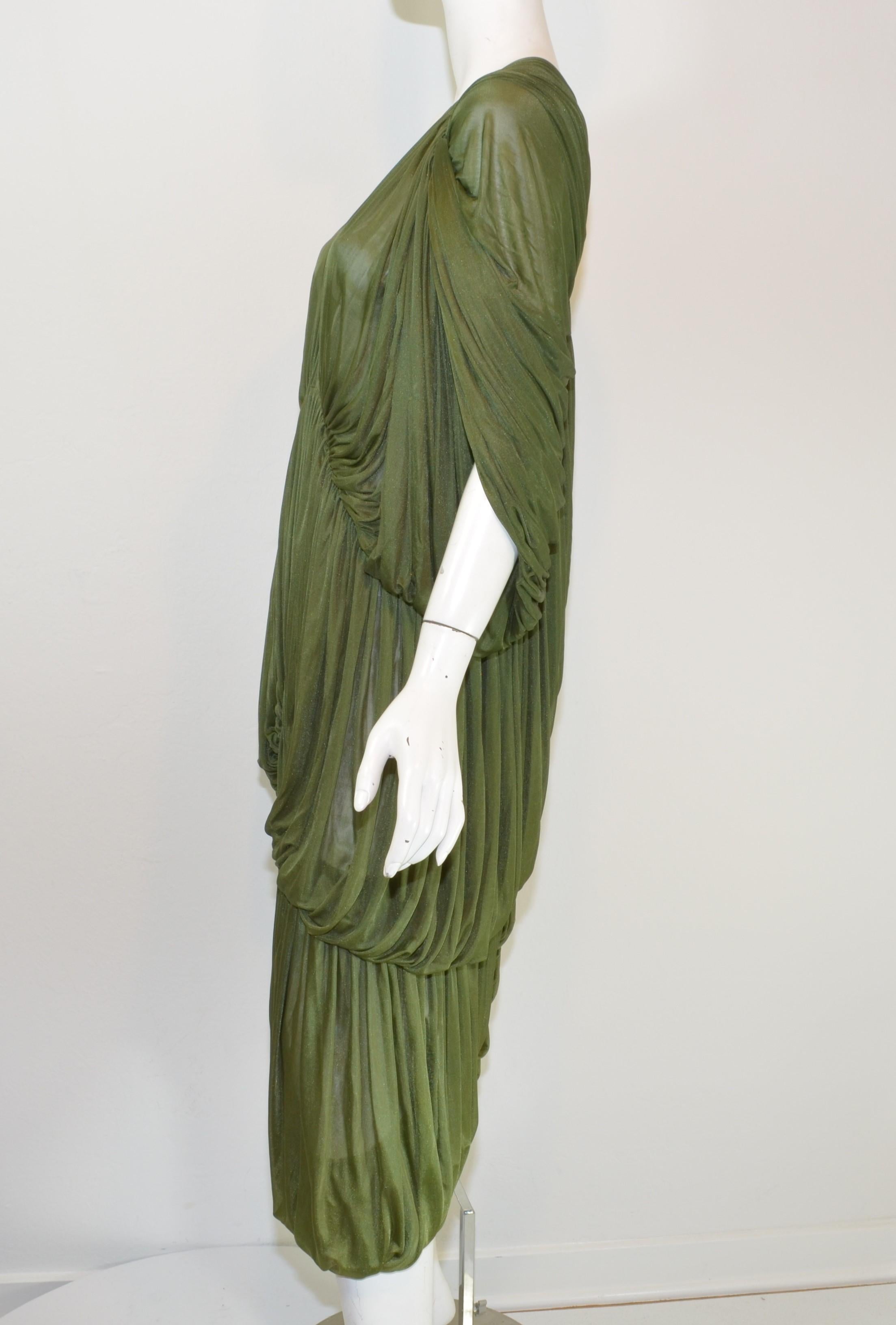 Norma Kamali OMO dress is featured in a olive green composed with a jersey fabric with hook-and-eye fastenings along the center and a ruched design throughout. Dress is in great condition with normal but light wears.