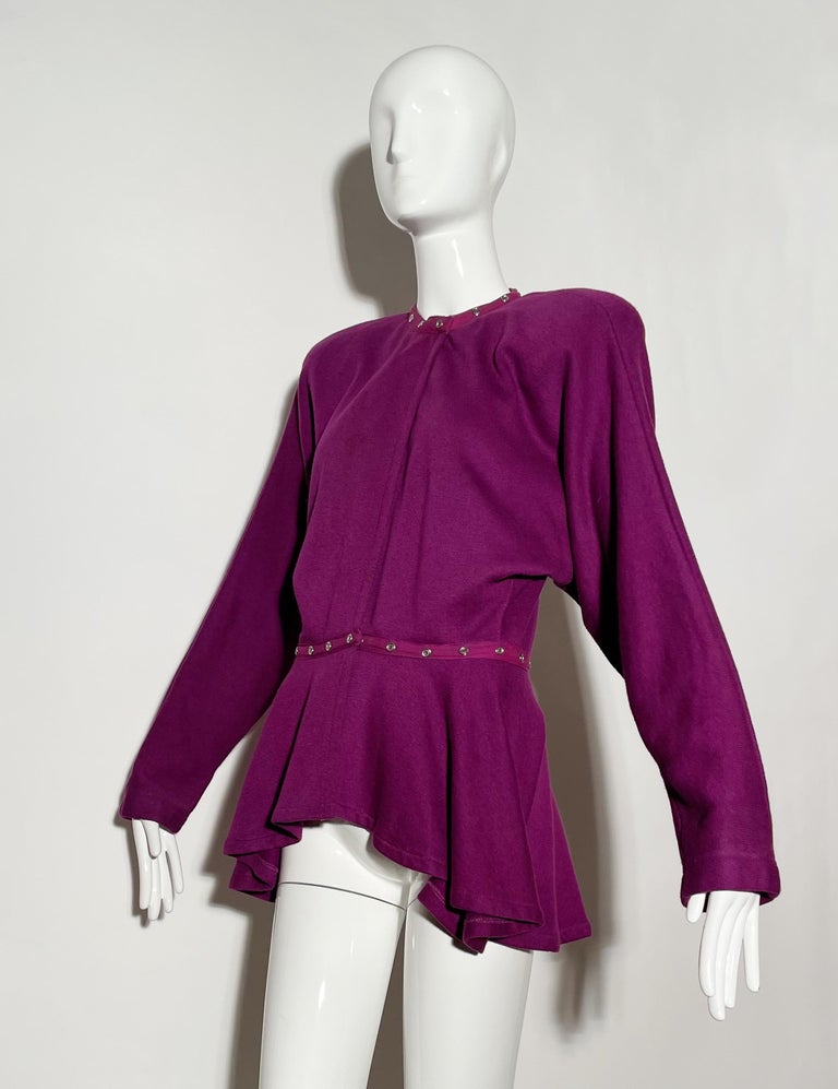 Purple sweatshirt blouse. Fleece lined. Shoulder pads. adjustable snap neck and waist detail. Batwing sleeve. 
*Condition: Excellent vintage condition. No visible Flaws.

Measurements Taken Laying Flat (inches)—
Shoulder to Shoulder: 17 in.
Sleeve